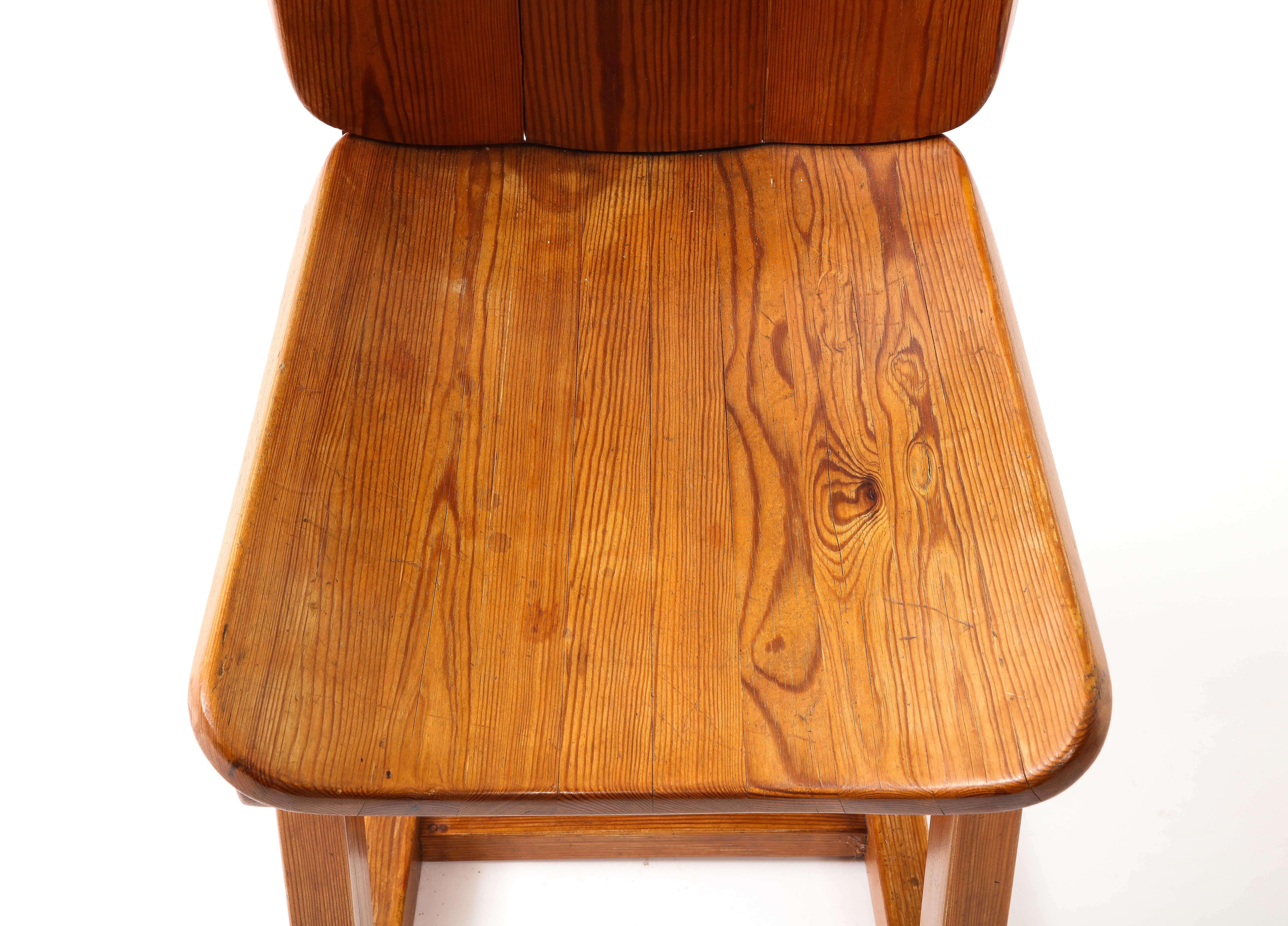 Solid Elm side chair with an interesting layered, geometric base.
