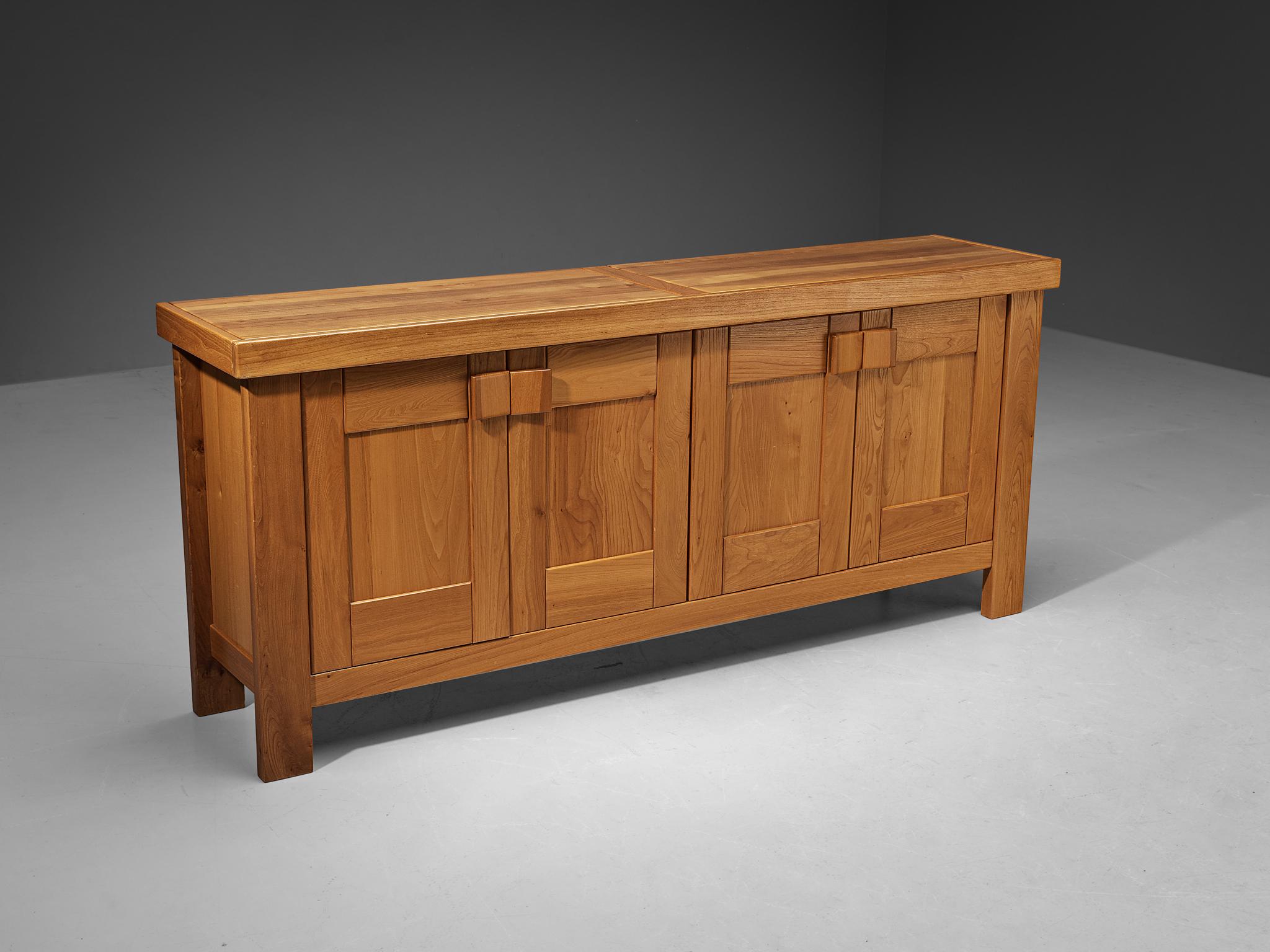 Maison Regain sideboard, elm, France, 1970s

Stunning French sideboard executed in elm, designed by Maison Regain. The buffet is sturdy and combines a simplified yet complex design with nifty, solid construction details that characterize Maison