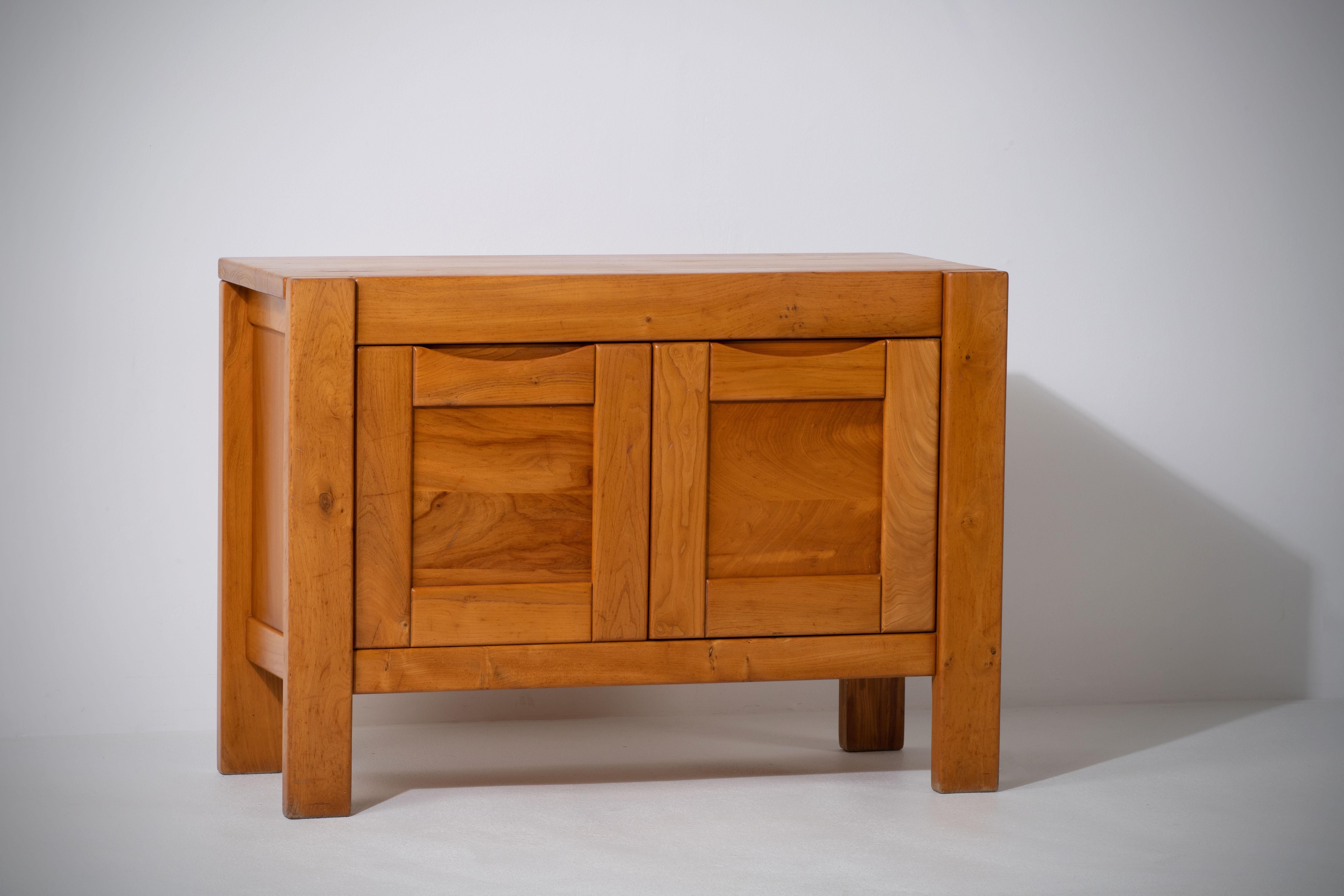 Introducing an impressive two-door sideboard attributed to the esteemed Maison Regain, a French furniture design house known for its exceptional craftsmanship and commitment to quality. Crafted in the late 1970s with skill and expertise in the