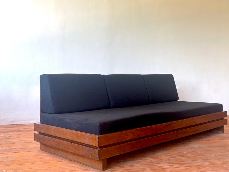 Large bench seat sofa produced in the 1970s by Maison Regain
Solid construction in elm wood reminiscent of Pierre Chapo. 
Beautiful grain to wood - simple lines
Newly upholstered seat and back cushion in black linen from France.