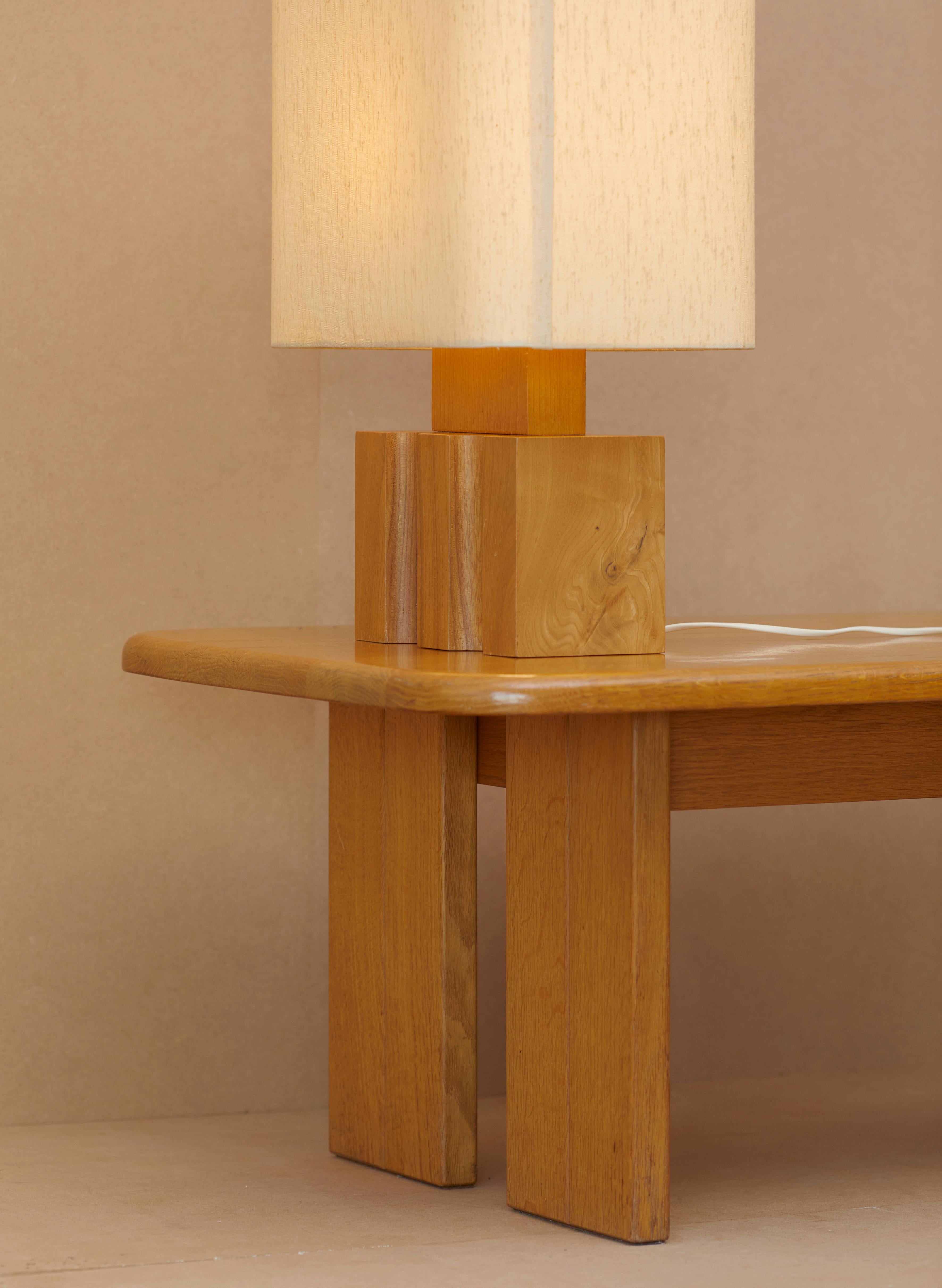 Maison Regain constructivist table lamp in solid elm. Rare original lampshade with large logo on one side.

Very good vintage condition.