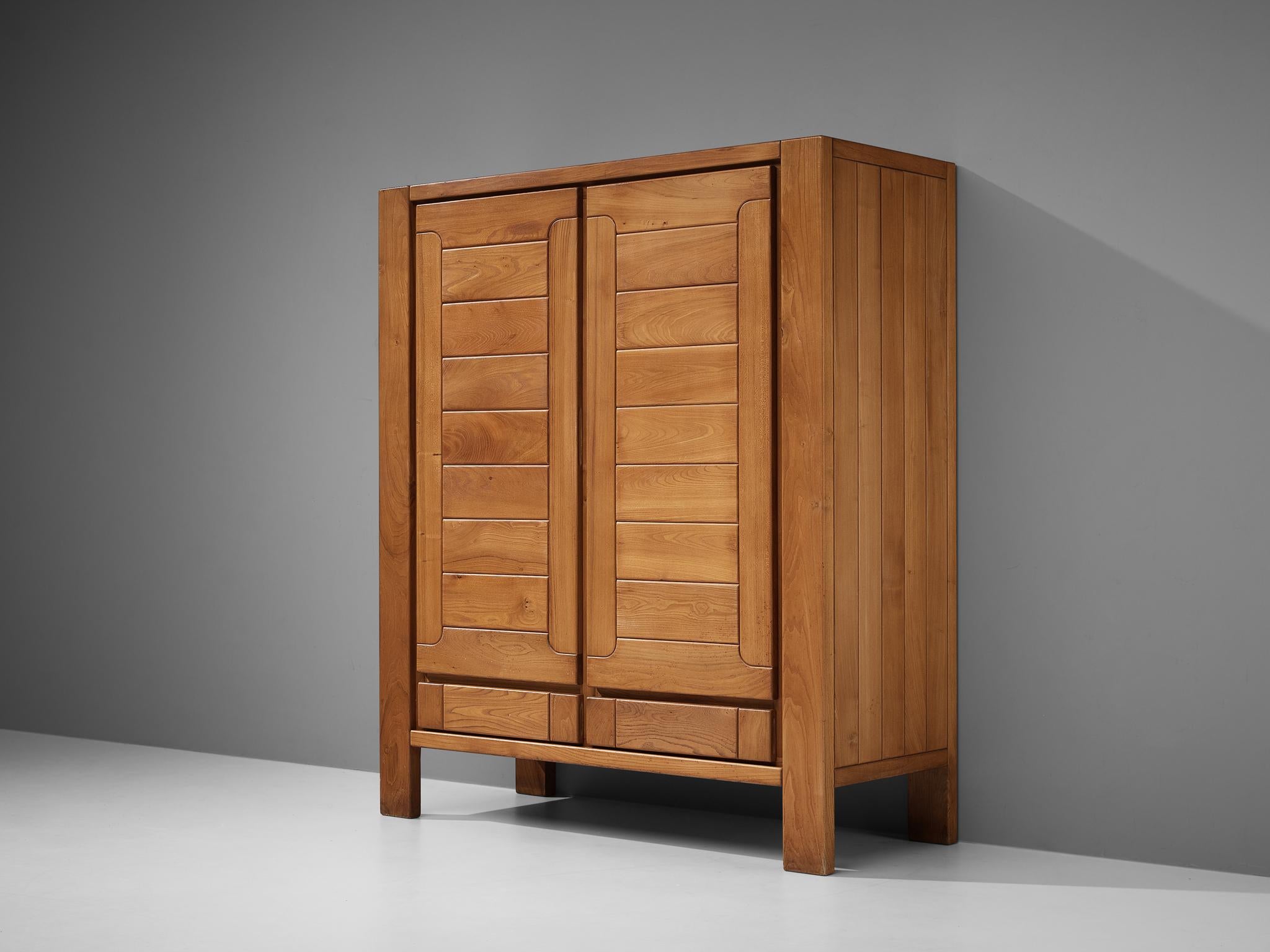Maison Regain, wardrobe, elm, France, 1960s

This wardrobe with two doors features the distinct look of Maison Regain. The elmwood is structured by geometric fields. Two drawers at the bottom and a cloths rack above, provide great storage