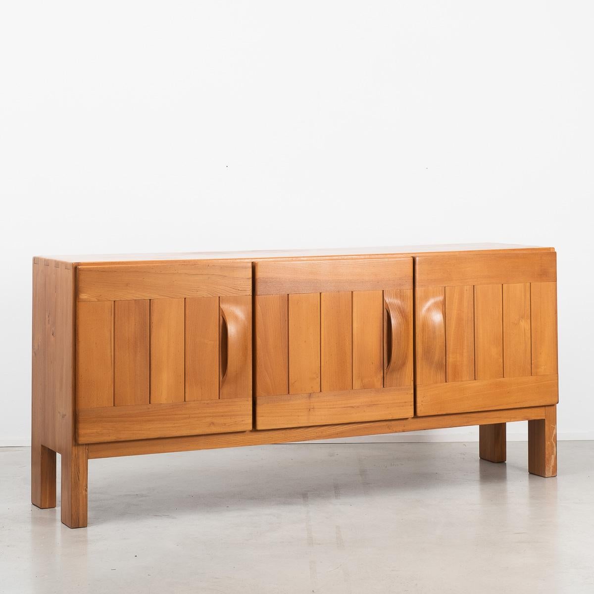 This well crafted sideboard by Maison Regain is made from solid elm wood. The key feature to this design is the curved handles which have been carved from a single piece of solid wood. The outer casing of this unit features great dovetail joins