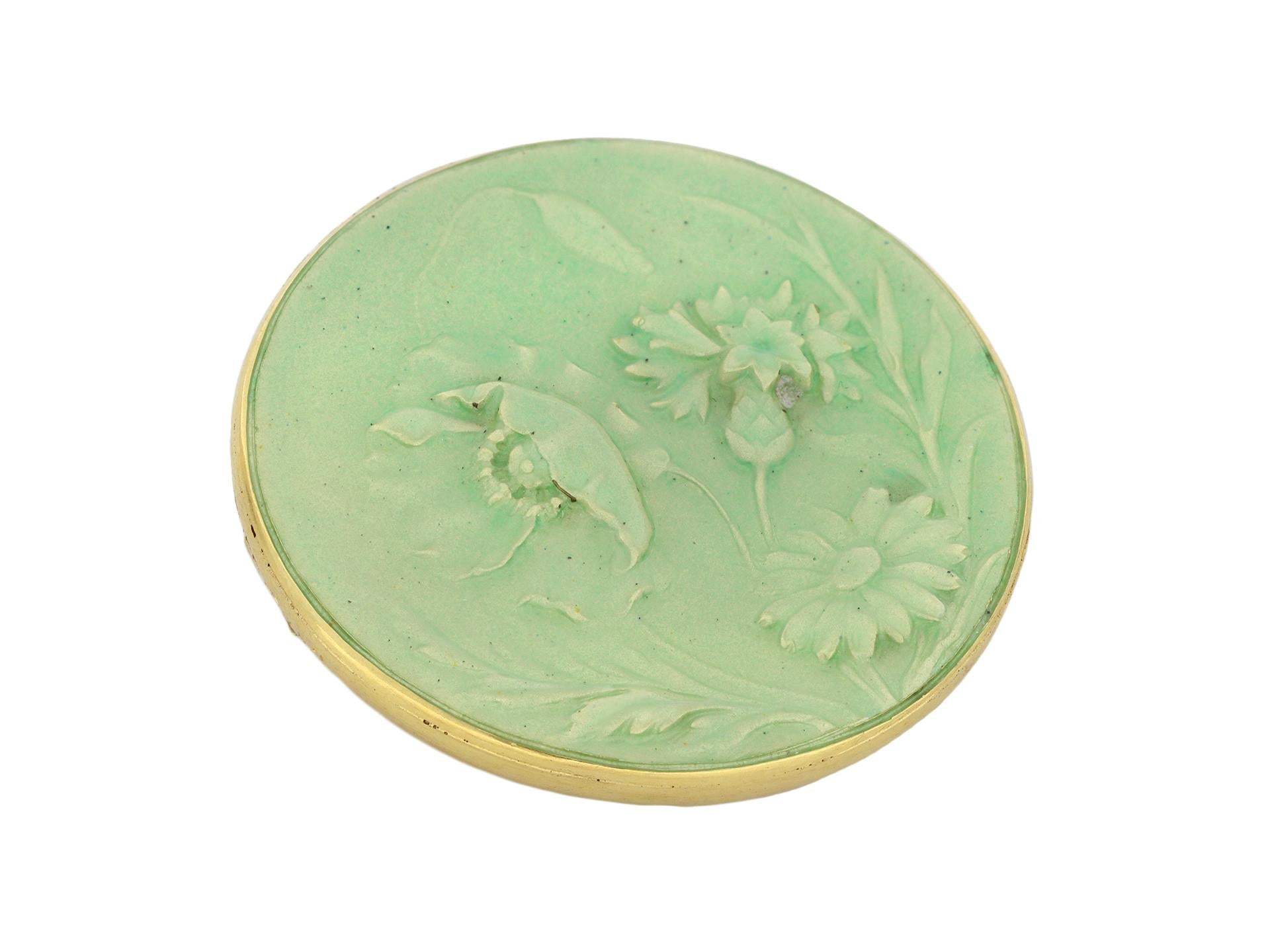 Enamel and gold brooch by Maison Vever Paris, French, circa 1900. An 18 carat yellow gold brooch in the form of a circular shallow concave disk decorated with a poppy, a daisy and a cornflower surrounded by foliage all in pale green enamel, the