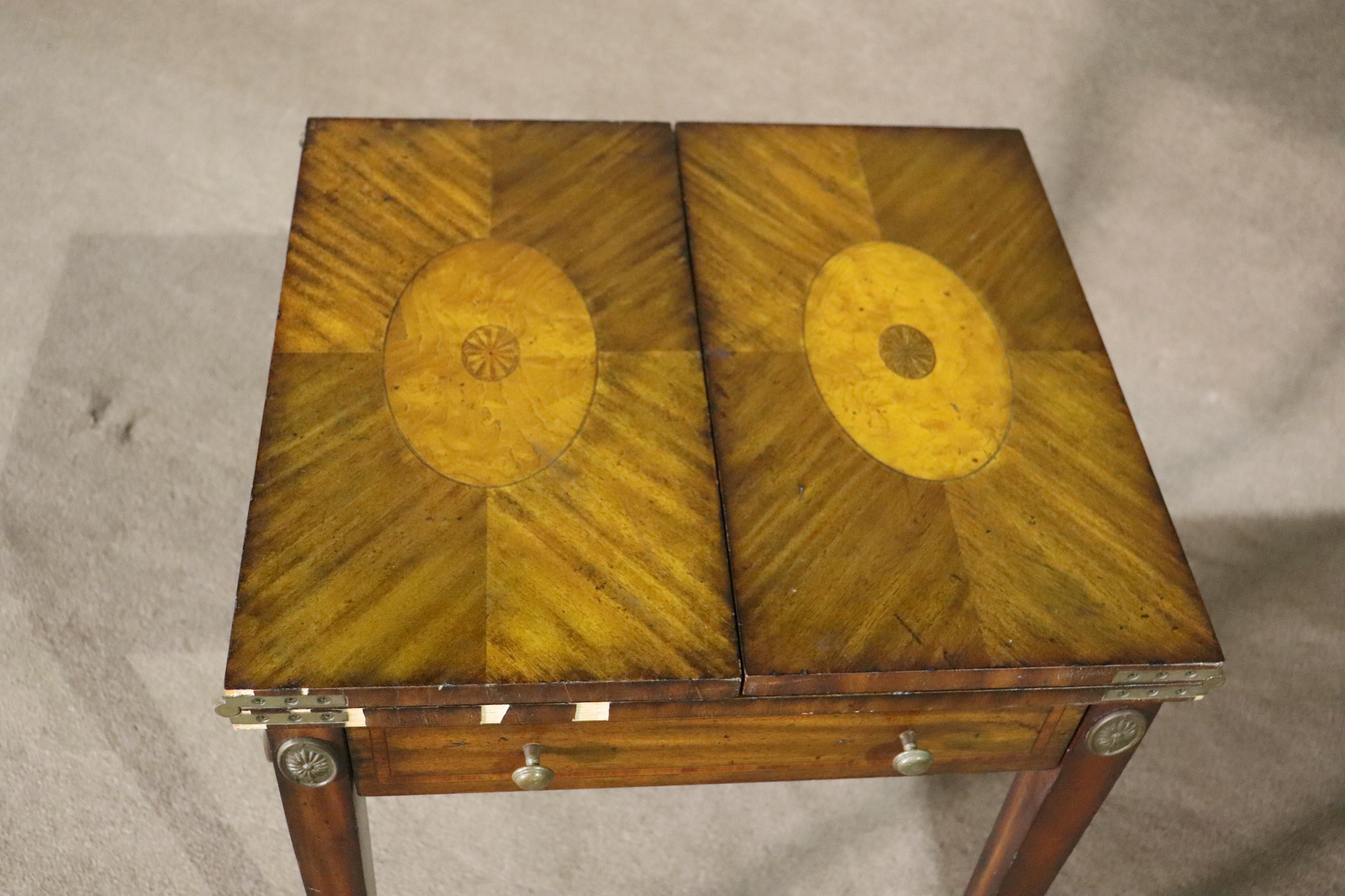 Antique style game table made by Maitland Smith. Beautiful inlay top that drops down to expose a checkerboard game table and leather topped leaves.
Please confirm location NY or NJ