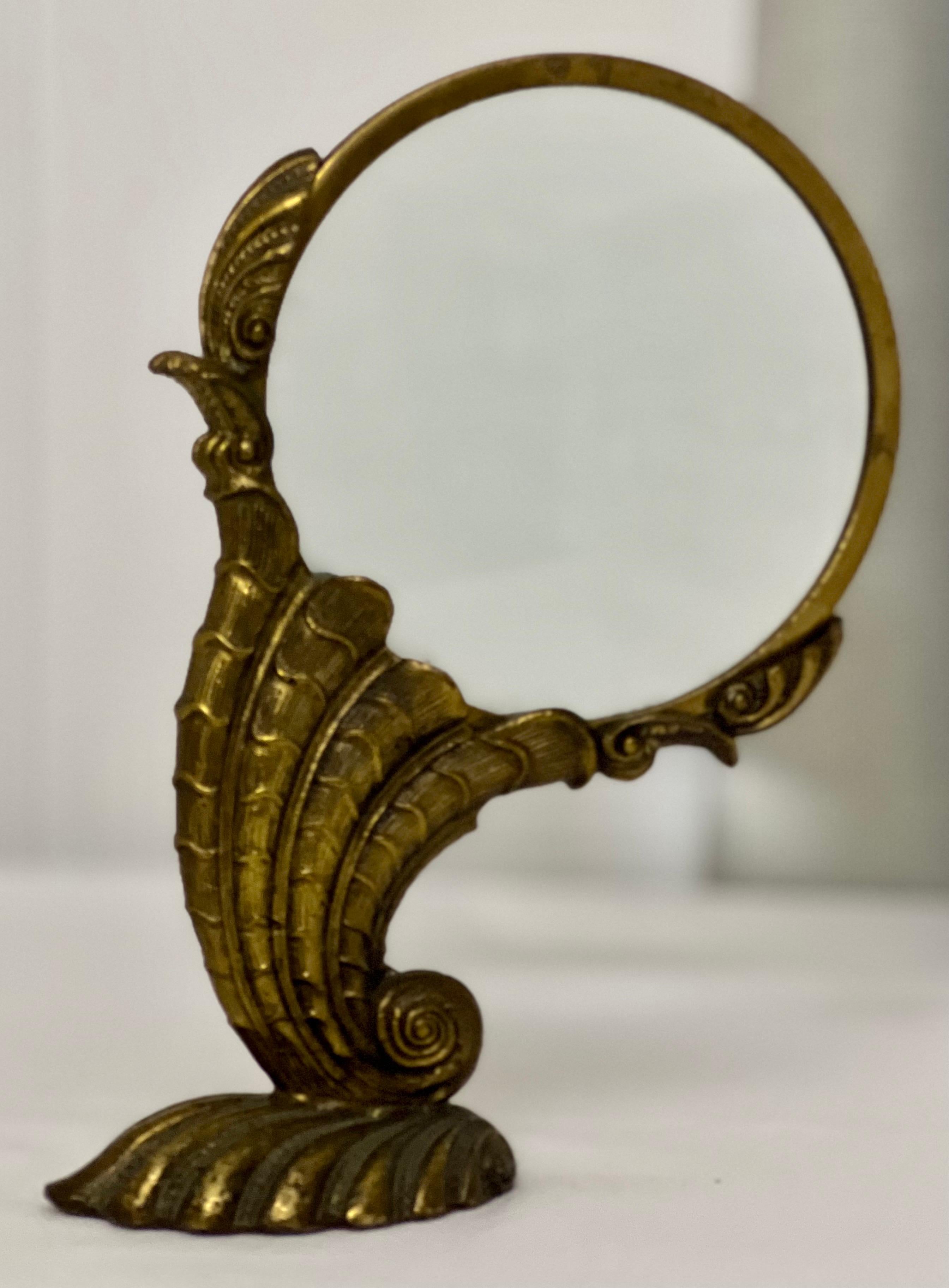 Maitland Smith Art Nouveau style large standing nautilus magnifying glass.

Lots of intricate details capture the beauty of this intriguing sea creature. It is free standing supported by a shell for the base with a nautilus extending upwards to
