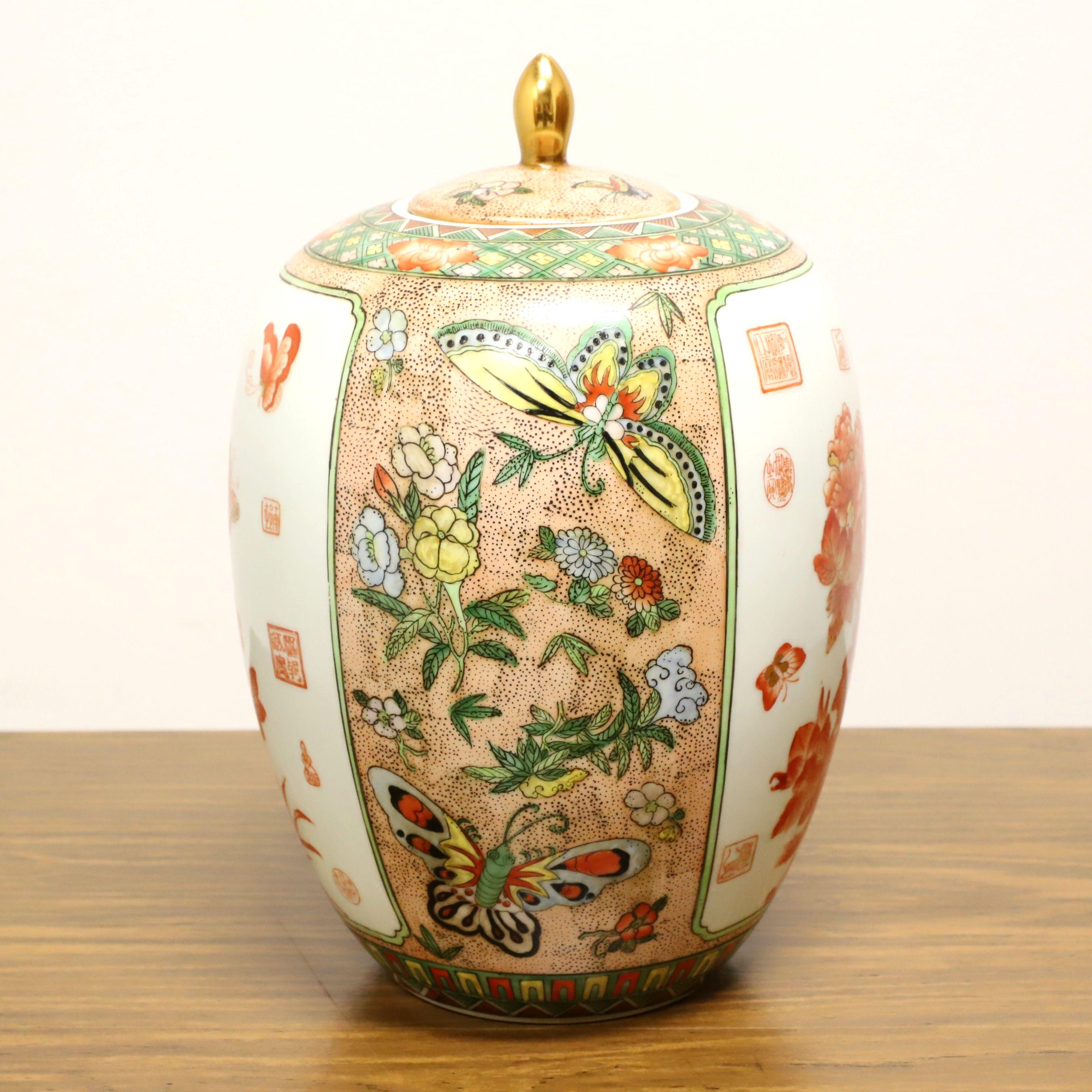 An Asian chinoiserie style ginger jar with lid by Maitland Smith. Fine porcelain body formed in Taiwan, hand painted with chinoiserie multi-color floral scenes with butterflies and re-fired in Hong Kong. Made in the late 20th Century.

Measures: