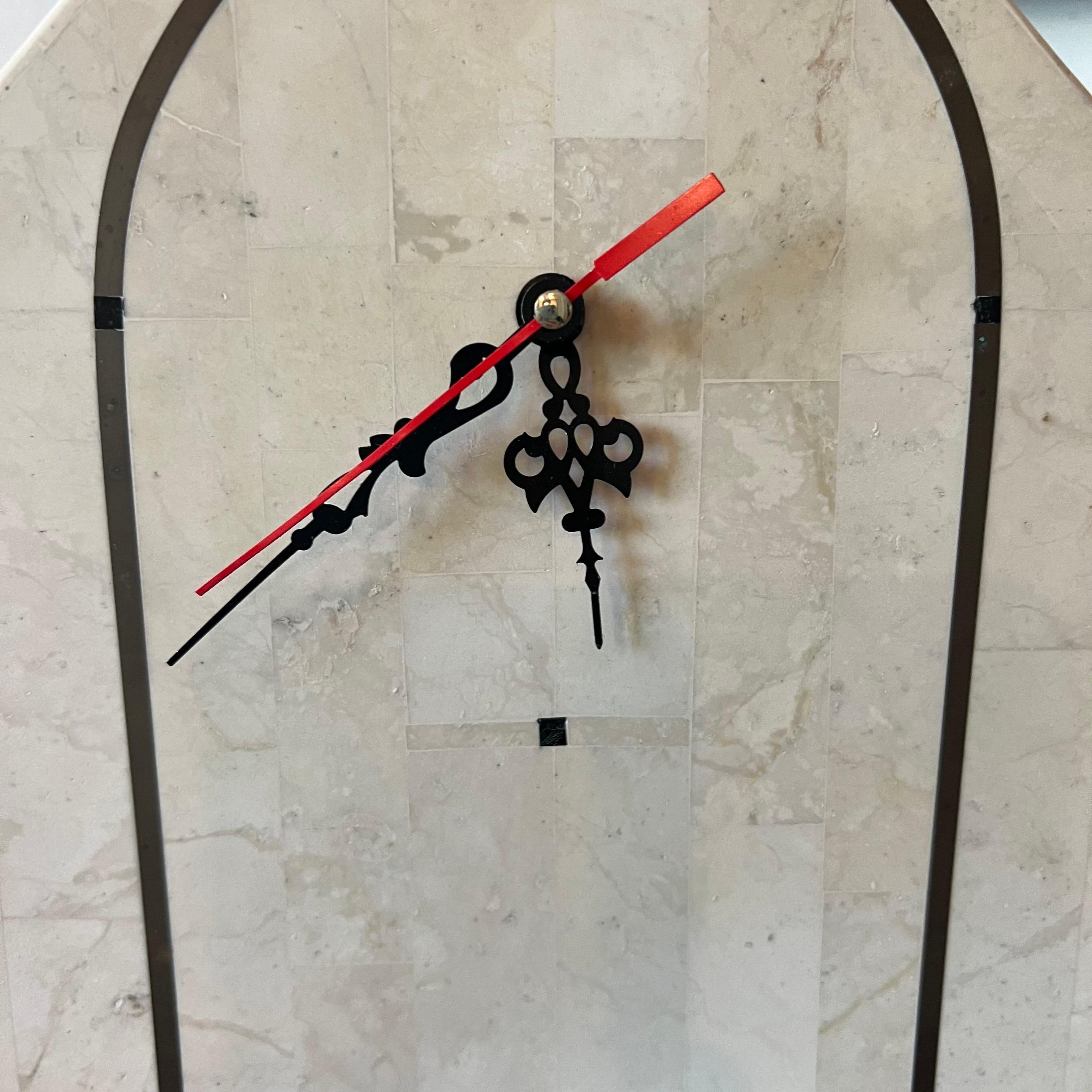Hello 1980’s Art Deco at its finest.  This fantastic faceless clock in tessellated stone and black marble is timeless (no pun intended).  There is a black arched inlay in the stone.  The marble spheres give it a very Memphis vibe.  Although this