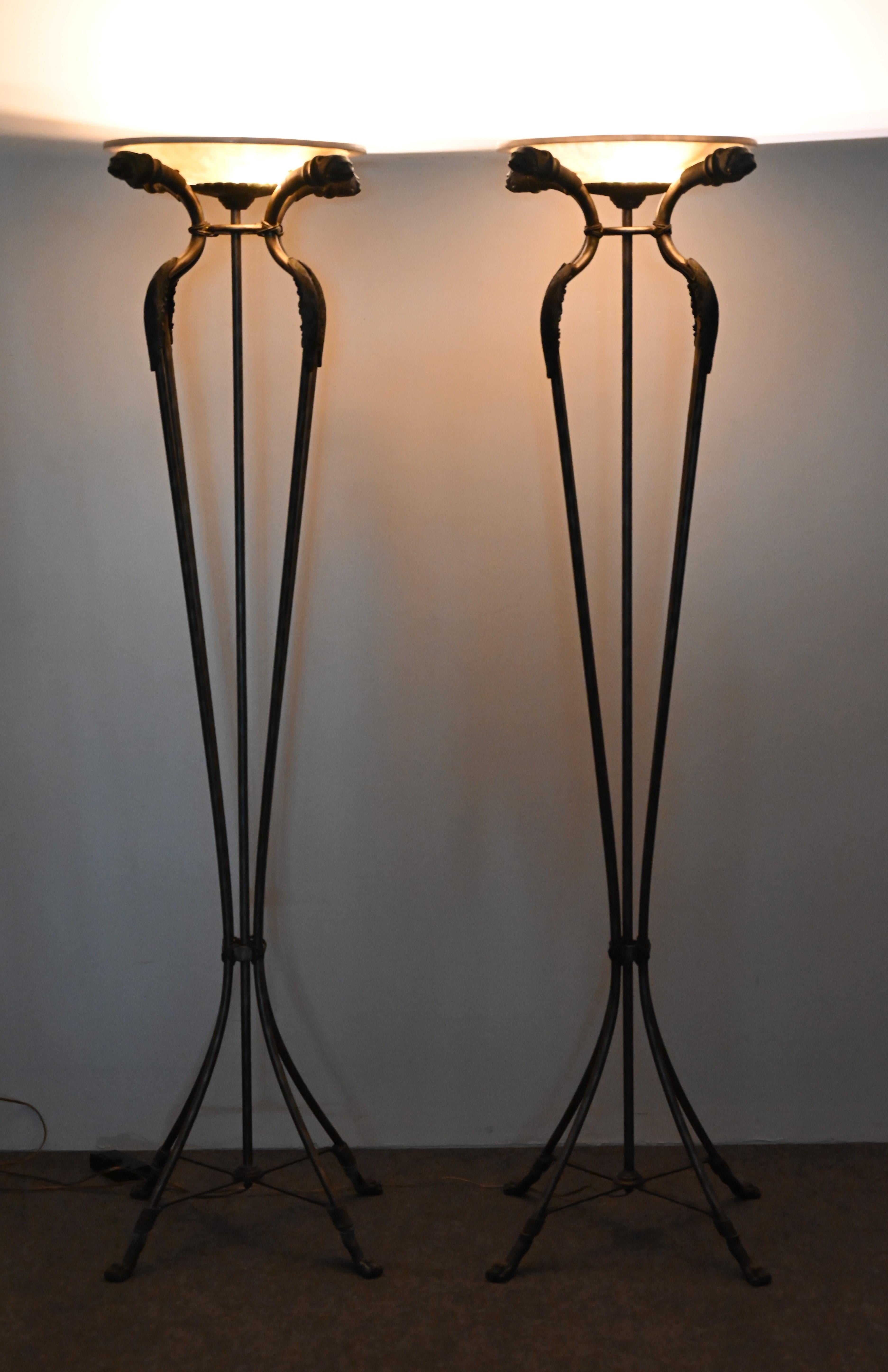 A wonderful pair of bronze over steel Torchieres with tesselated shades. The pair of lamps is attributed to Maitland Smith, however, they are unmarked. This lovely pair of floor lamps would work well with antiques and Neoclassical or Empire