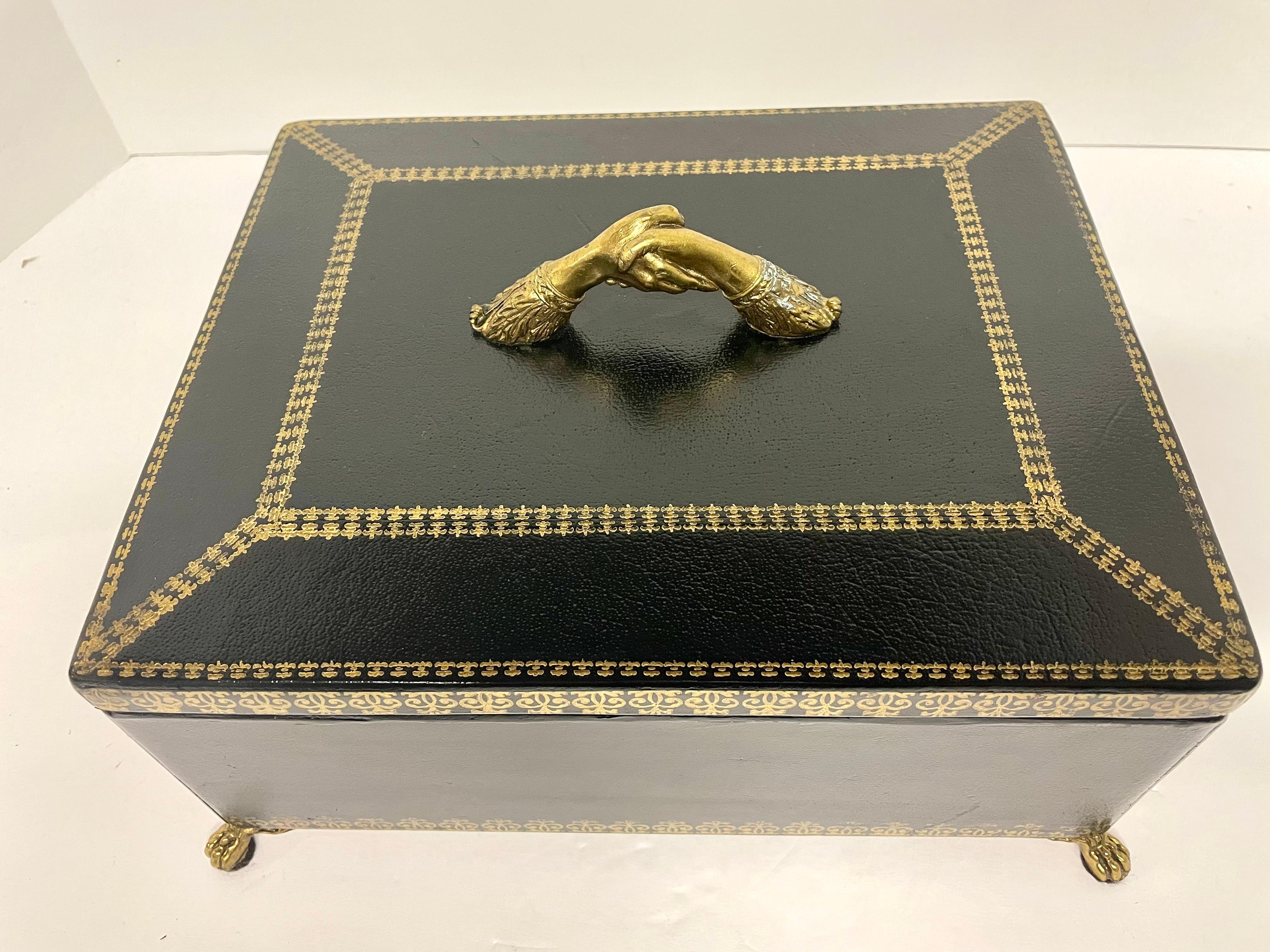 Maitland Smith black leather footed box with tags on bottom. Bronze feet, handshake handle on top. Marked 173 on bottom. From an estate in Charlottesville, VA.