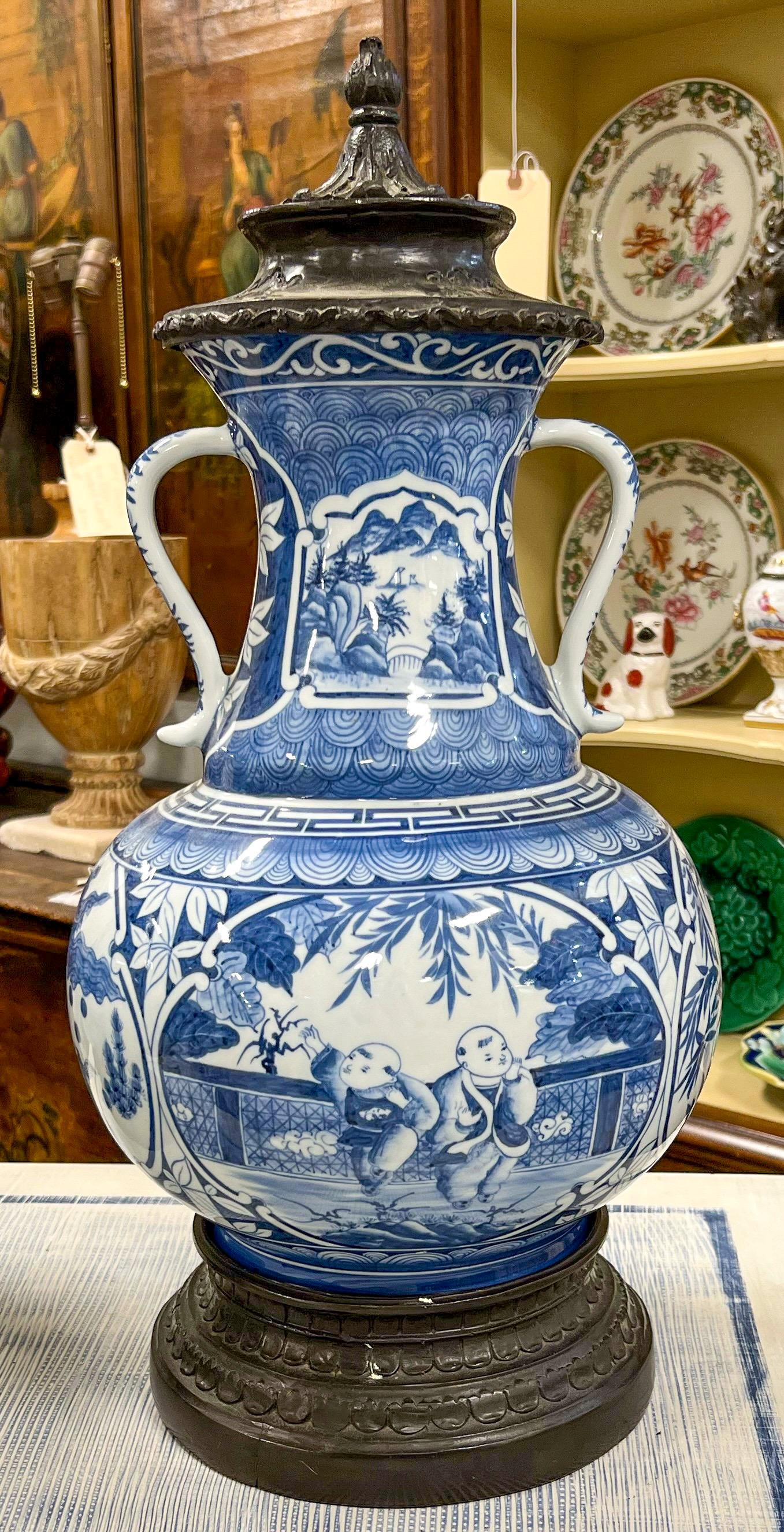 This is a pair of blue and white transferware chinoiserie ginger jars by Maitland - Smith. The caps and bases are cast bronze. They are in very good condition.