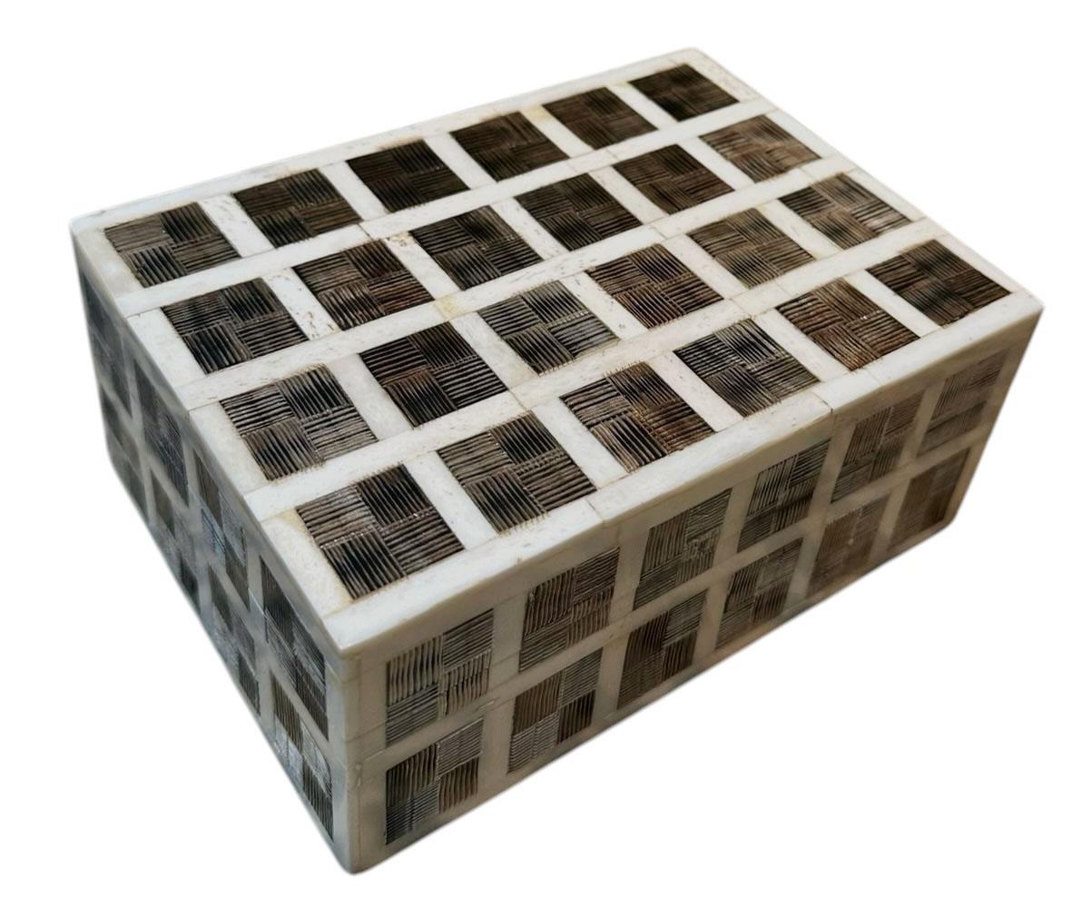 This exquisite Maitland Smith box showcases a striking bone inlaid design on rich satinwood, with meticulously carved out square patterns that create a visually dynamic effect. Crafted in the United States in the 1970s, this piece embodies the