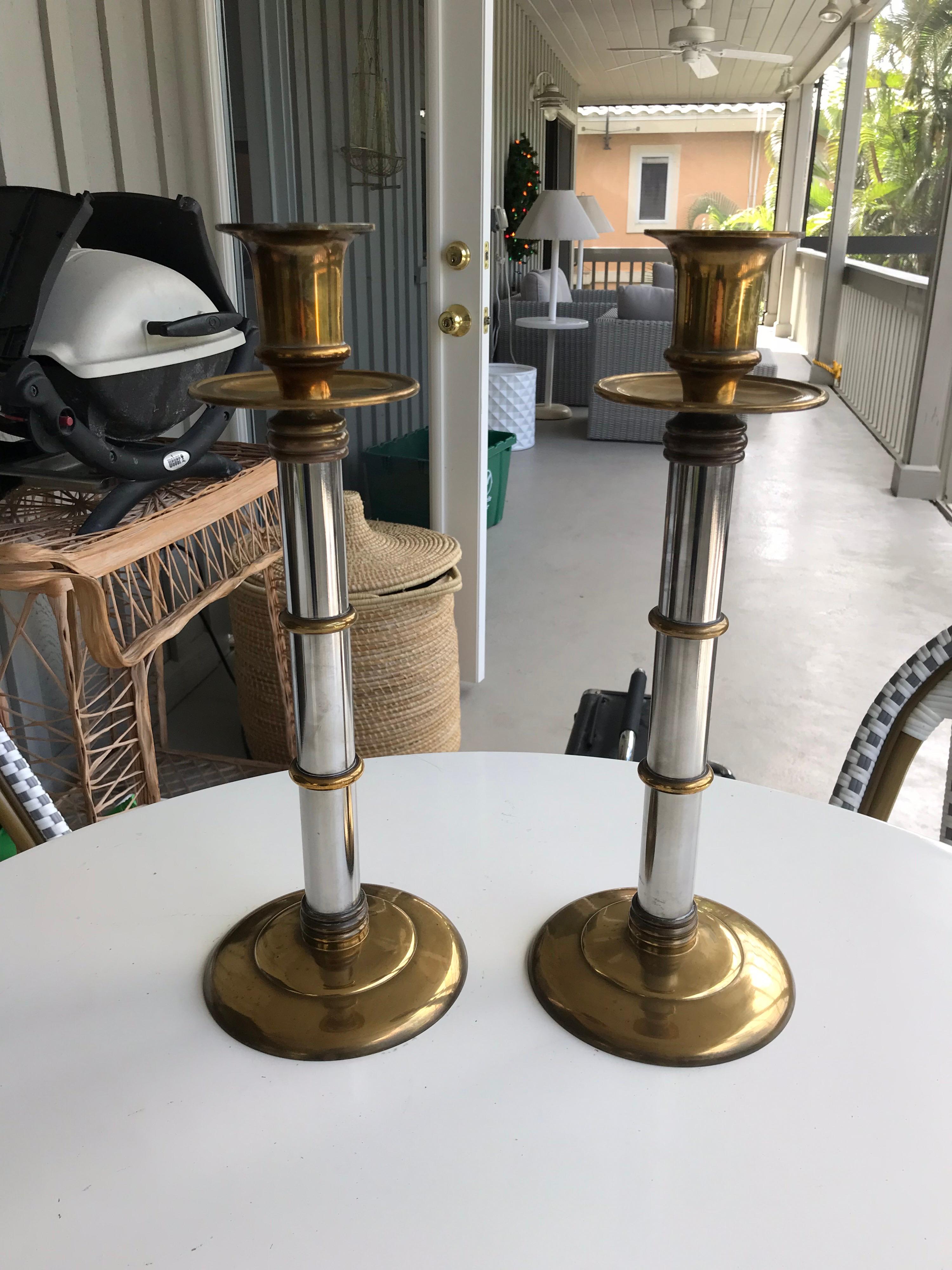 This is a pair of heavy brass and chrome candlesticks by Maitland Smith 
The banding has kind of a bamboo look but would go in most any decor.