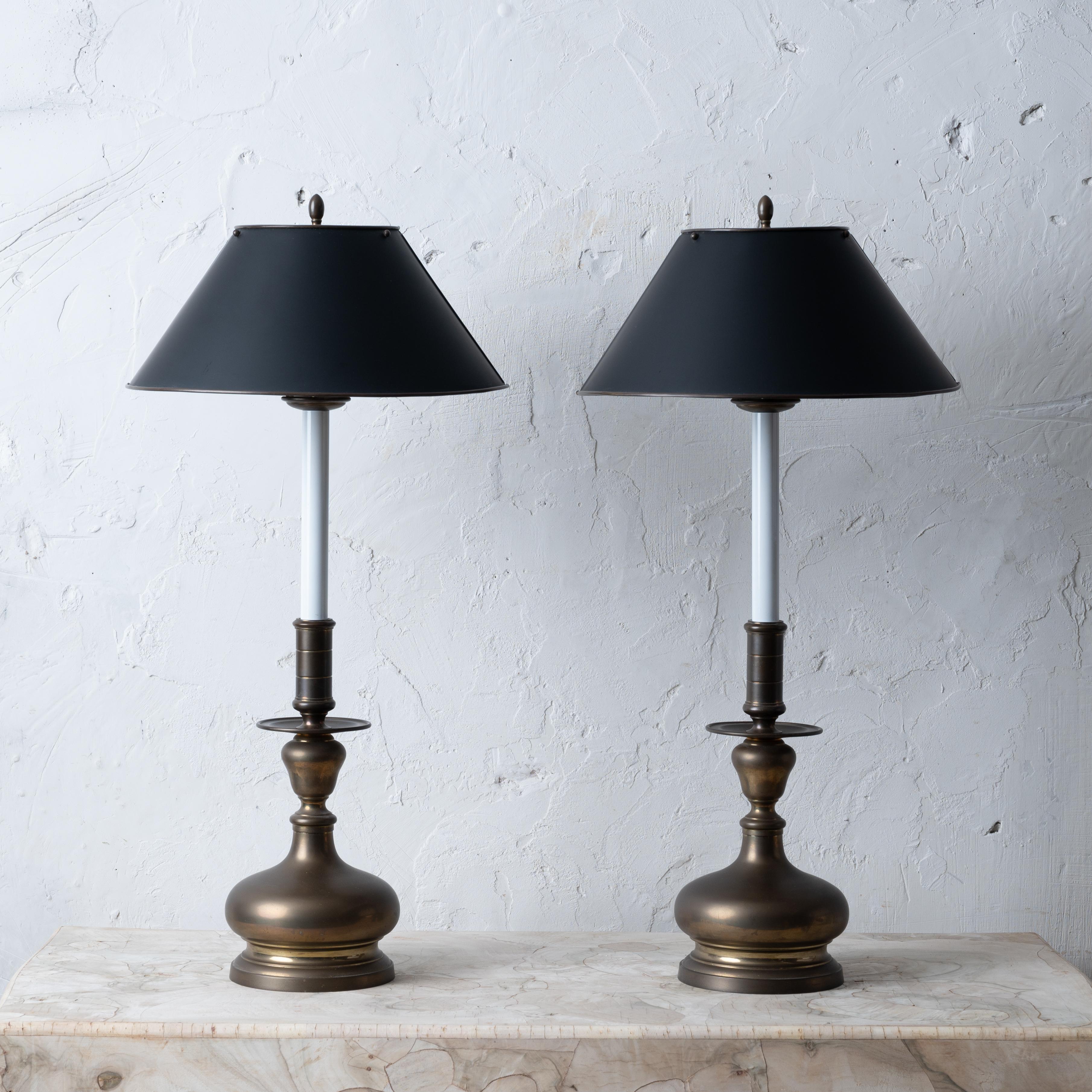 A pair of Maitland-Smith brass table lamps with metal shades. 

9 ½ inches wide at base by 29 inches tall;  shade measures 14 inches wide by 6 inches tall


