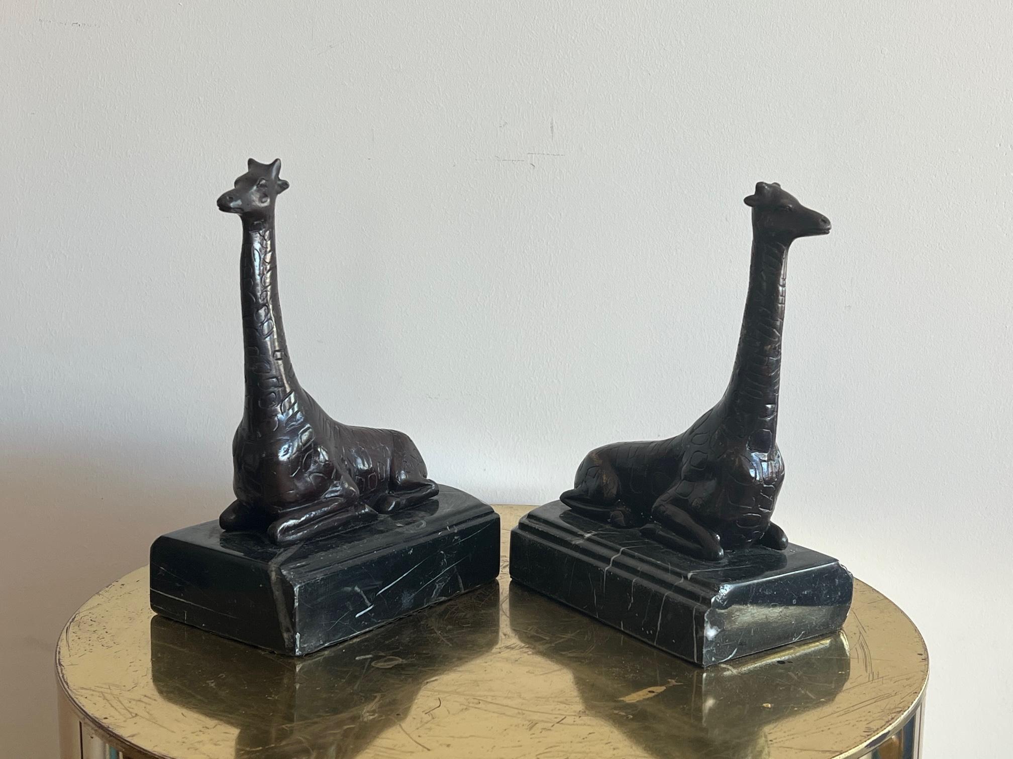 A pair of unusual, handmade bronze giraffe bookends on marble bases made by Maitland Smith.