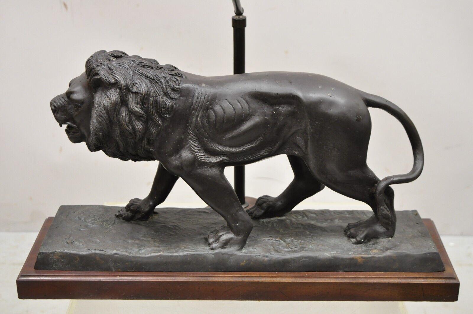 Maitland smith bronze lion table lamp with faux tooled leather shade. Item features original faux tooled leather shade, finely detailed cast bronze lion figure, original label, very nice vintage item, quality craftsmanship, great style and form.