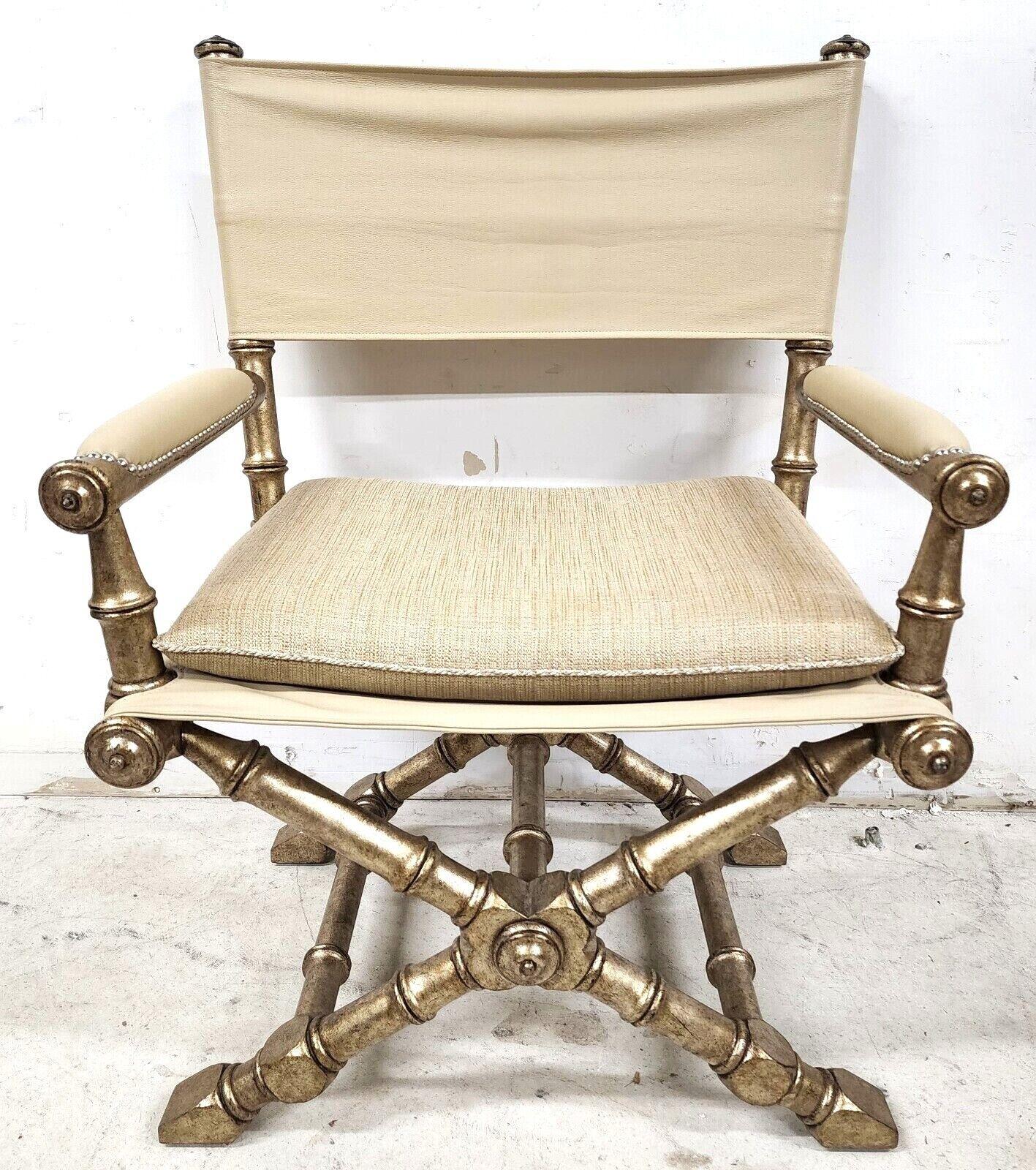 Offering One of our recent palm beach estate fine furniture acquisitions of a
champagne/silver finish campaign style accent chair attributed to Maitland Smith
Featuring leather back, leather armrests, and a leather seat topped with a wool-covered