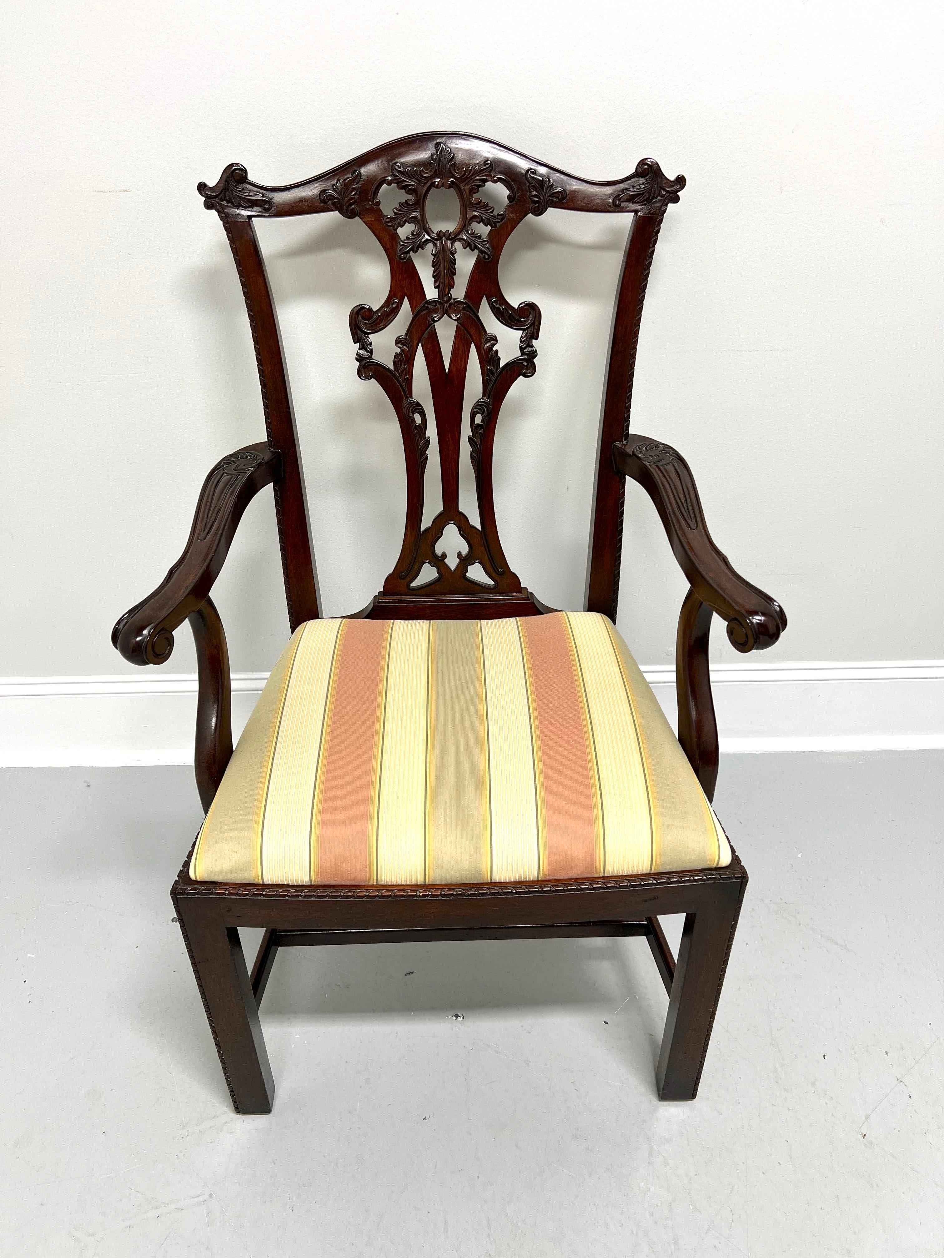 A Chippendale style armchair by Maitland Smith. Solid mahogany with decoratively carved crest rail & backrest, curved carved arms with paw-like hand rests, decorative beading details to stiles, apron & legs, straight front legs and stretchers. Seat