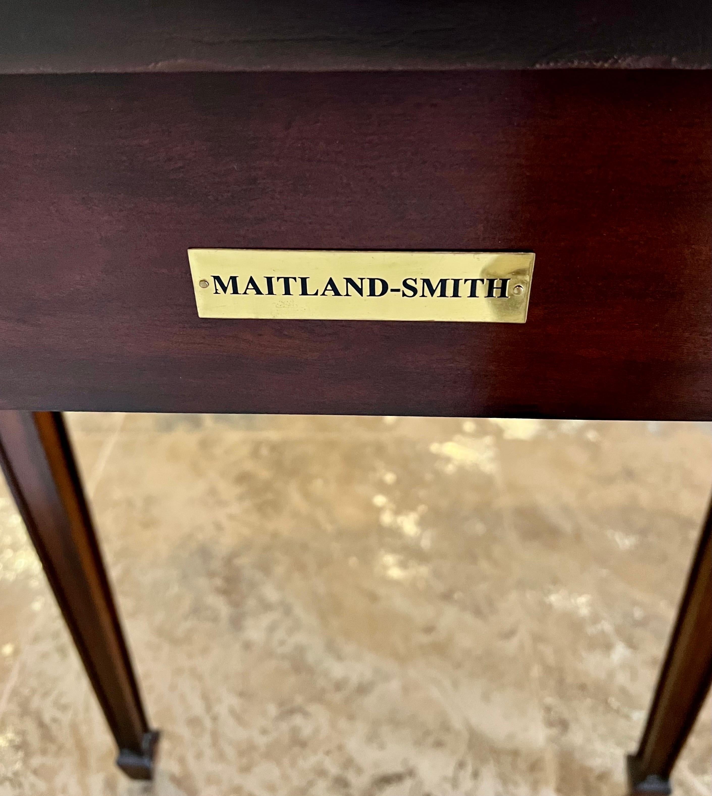 Classic mahogany console table with leather top and carved details on front and corners. Supported on six, not four, tapered legs. Signed by Maitland Smith. Why not own the best?