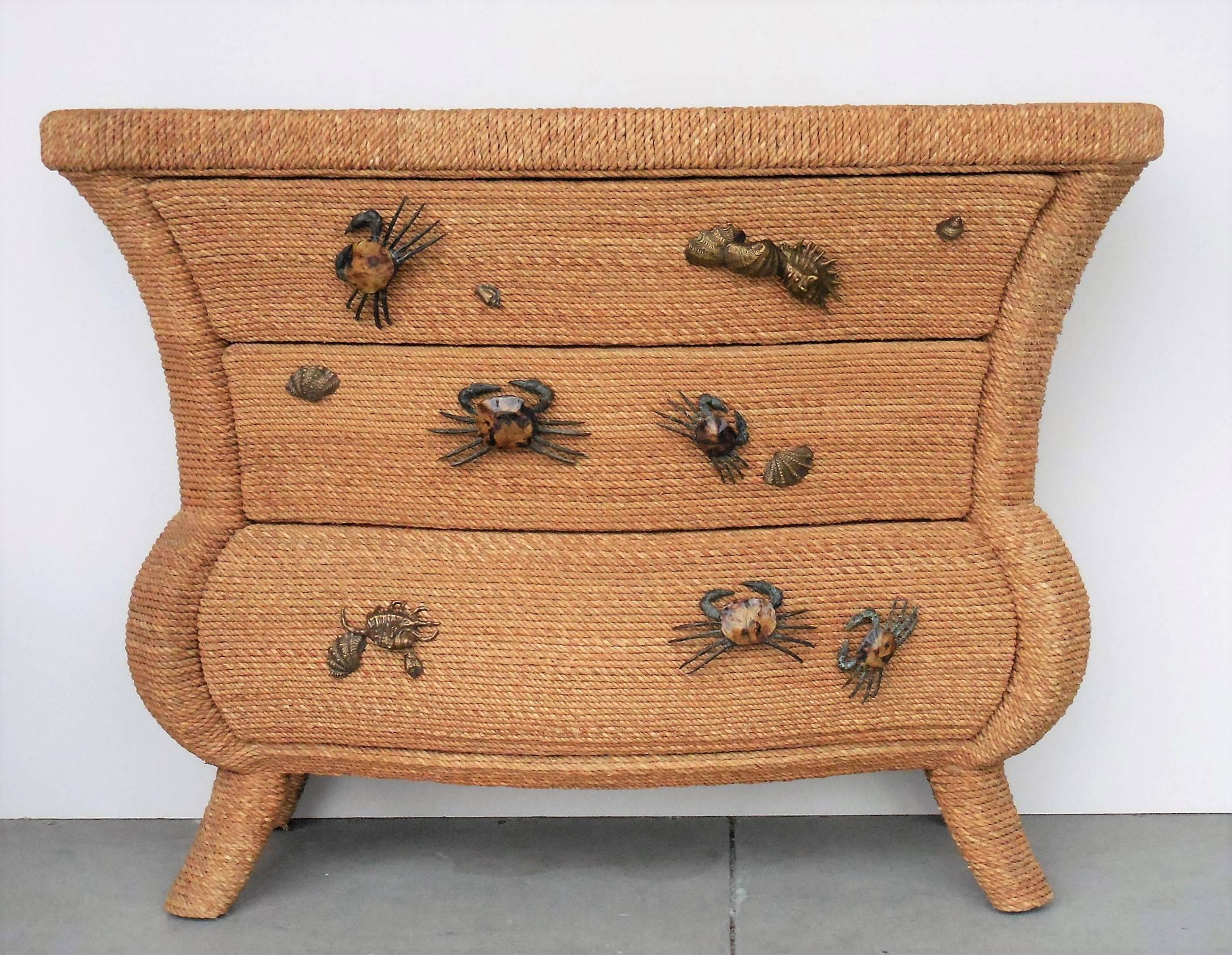 Stunning chest or console by Maitland Smith. Very much in the style of Christian Astugueiveille. The whole cabinet is meticulously covered with maguey rope and there are life-size crabs crawling on the front along with clusters of sea shells. Both