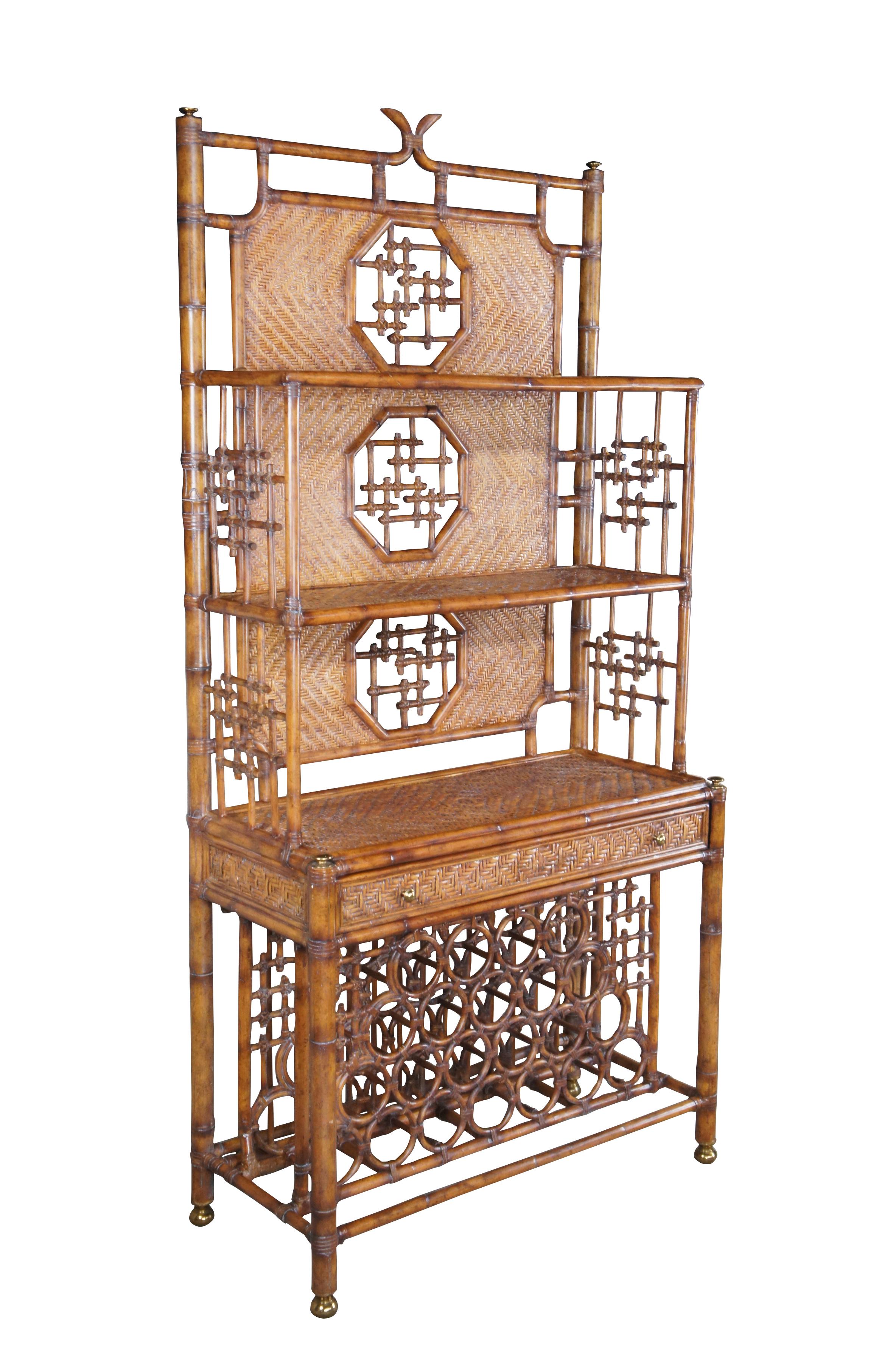 Stately Etagere display or wine dry bar by Maitland Smith, circa 1990s.  Made from faux bamboo and woven rattan with two shelves over a table surface, drawer and lower wine or liquor bottle storage.  Features octagonal windows along the back with