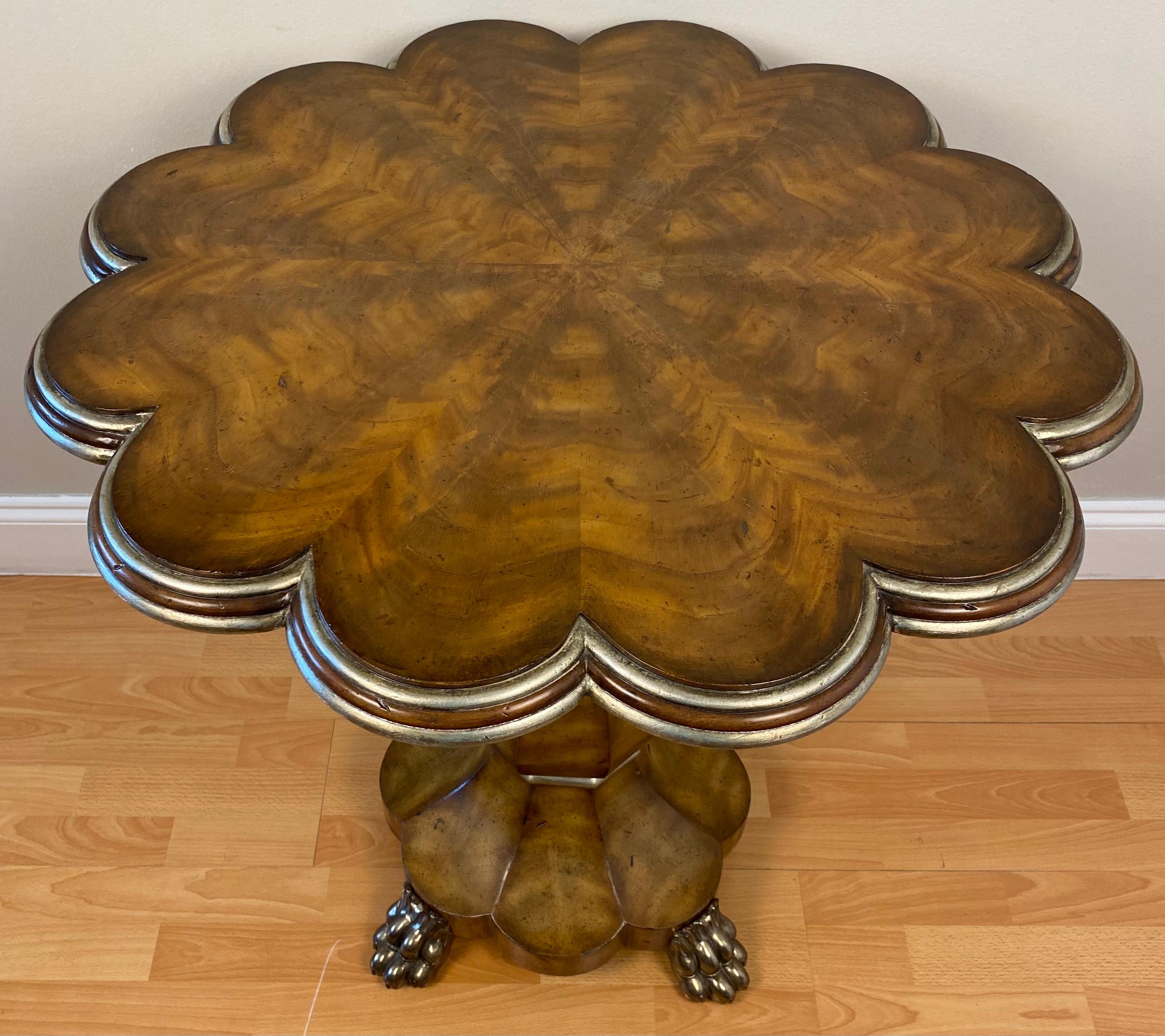A fine burl mahogany (ronce d'acajou) American designed side table by Maitland Smith. One pedestal on a three legged stand accentuated with a silver leaf wood molding details, framed by carved edges molding and supported by a hand carved detailed