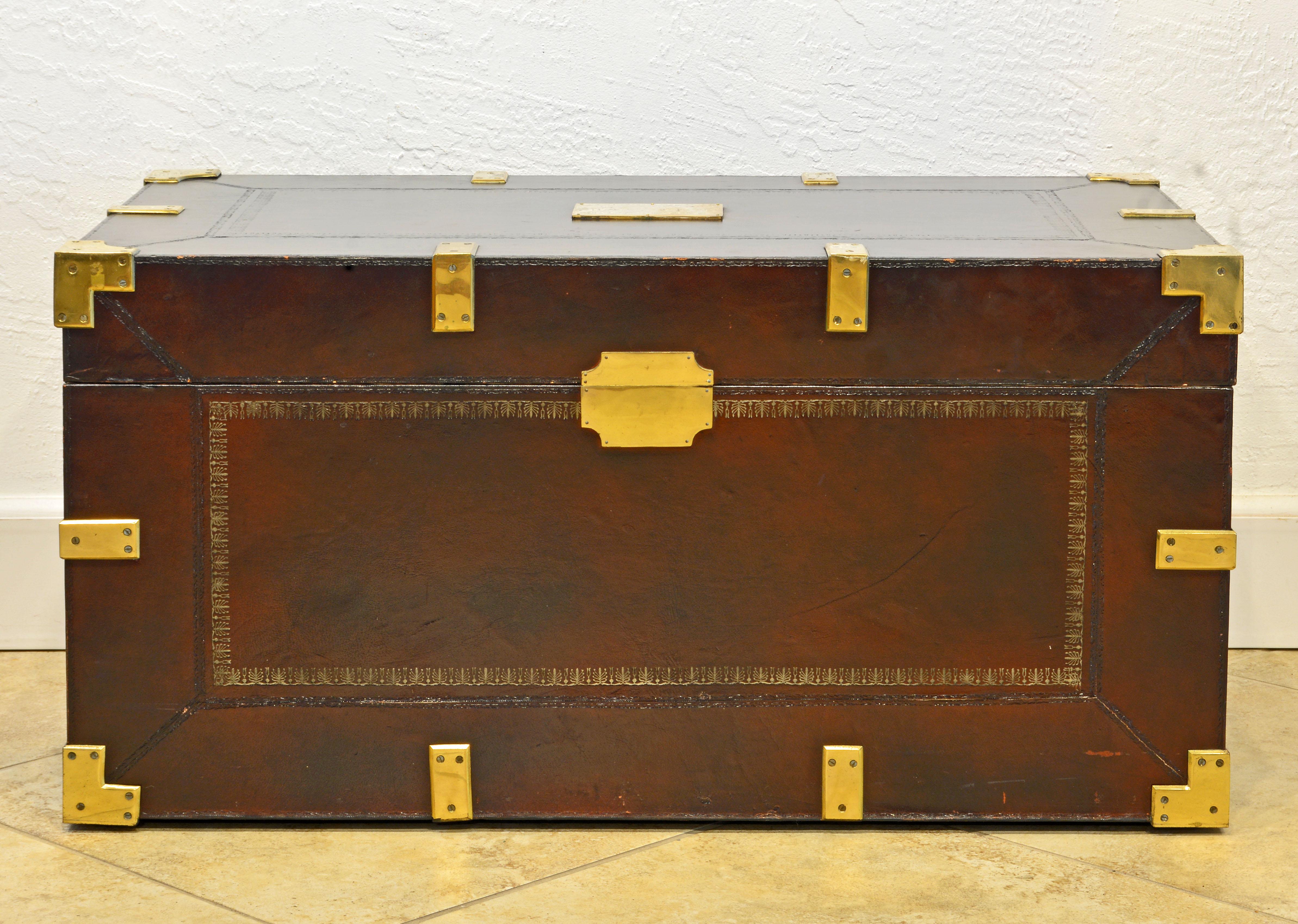 This Maitland Smith colonial campaign style is a box constructed of wood covered with gilt tooled leather on all sides. And mounted with solid brass mounts. The lid opens up to a lined roomy interior. It is retaining the original Maitland Smith