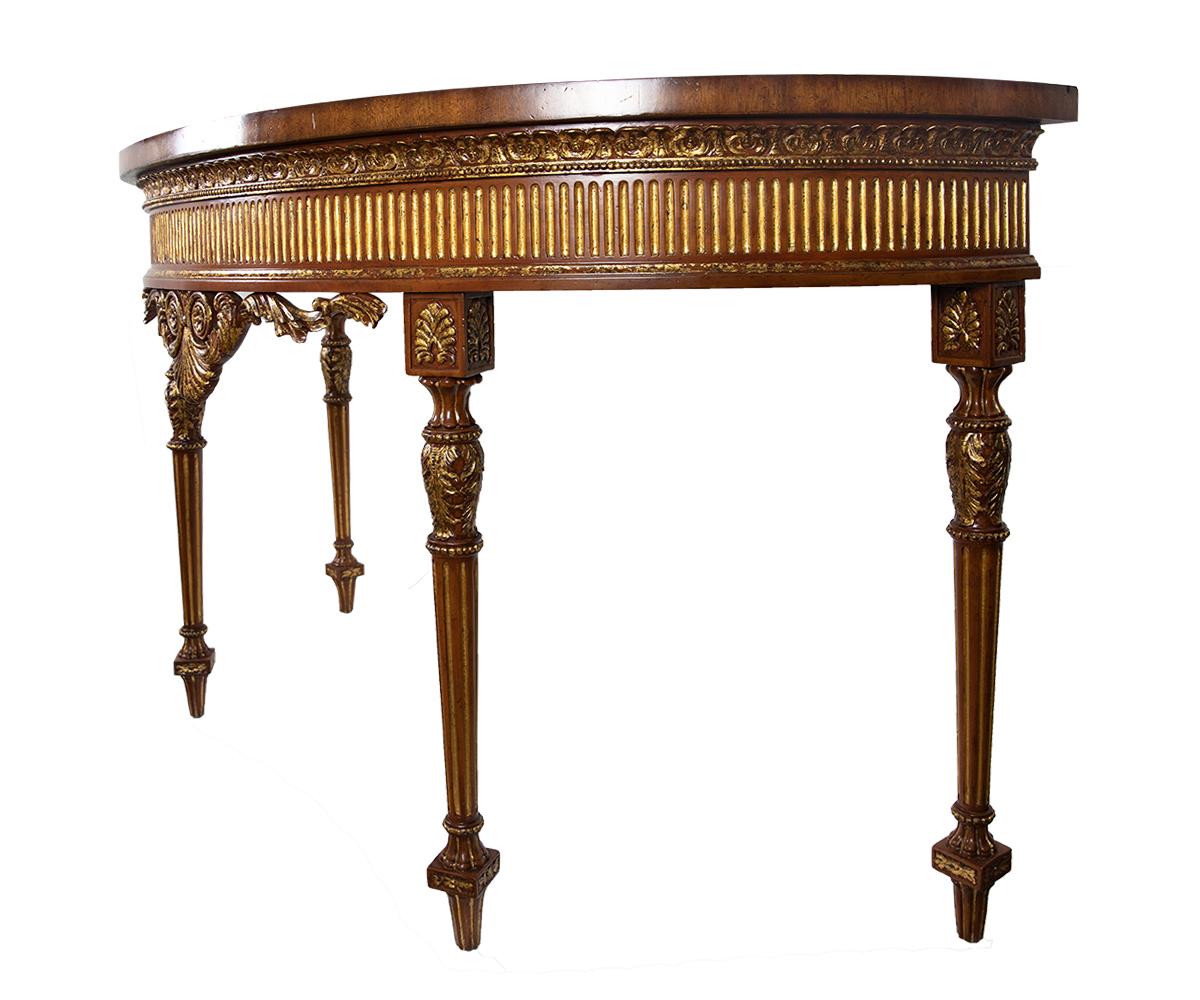 Refined half-round Maitland Smith mahogany with satinwood inlay console table. Square tapered legs with semi gilding around apron and legs.