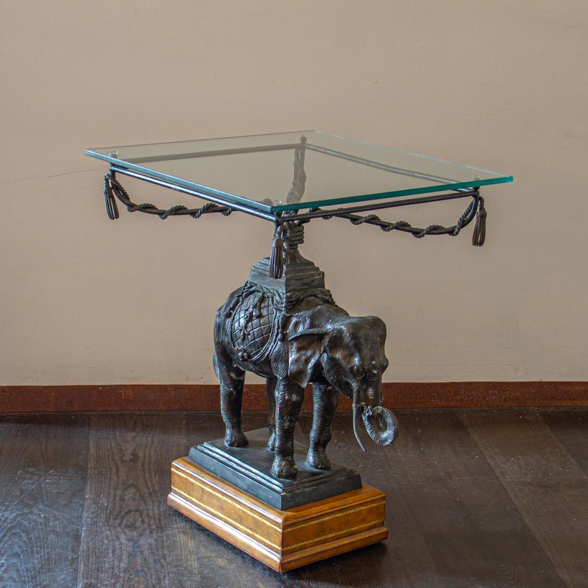 A Maitland Smith designed side table with a highly detailed bronze elephant surmounted by a glass top set upon swag rope details, 1970s

Maitland Smith was established in 1979. They used highly skilled artisans and quality raw materials to create