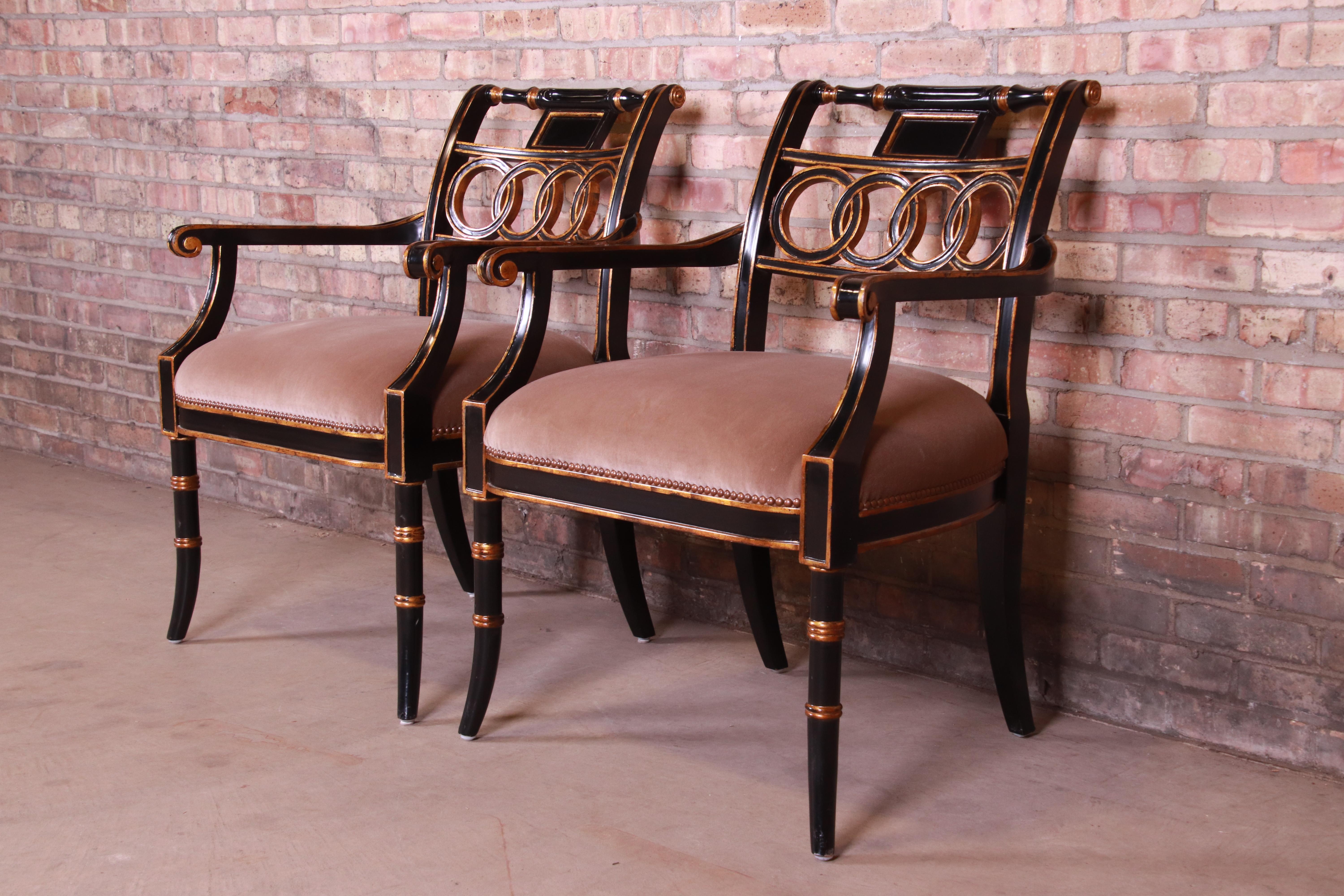 An exceptional pair of Regency style club chairs or dining armchairs

By Maitland Smith,

Late 20th century

Ebonized and gold gilt solid wood frames, with tan velvet upholstered seats.

Measures: 26.25