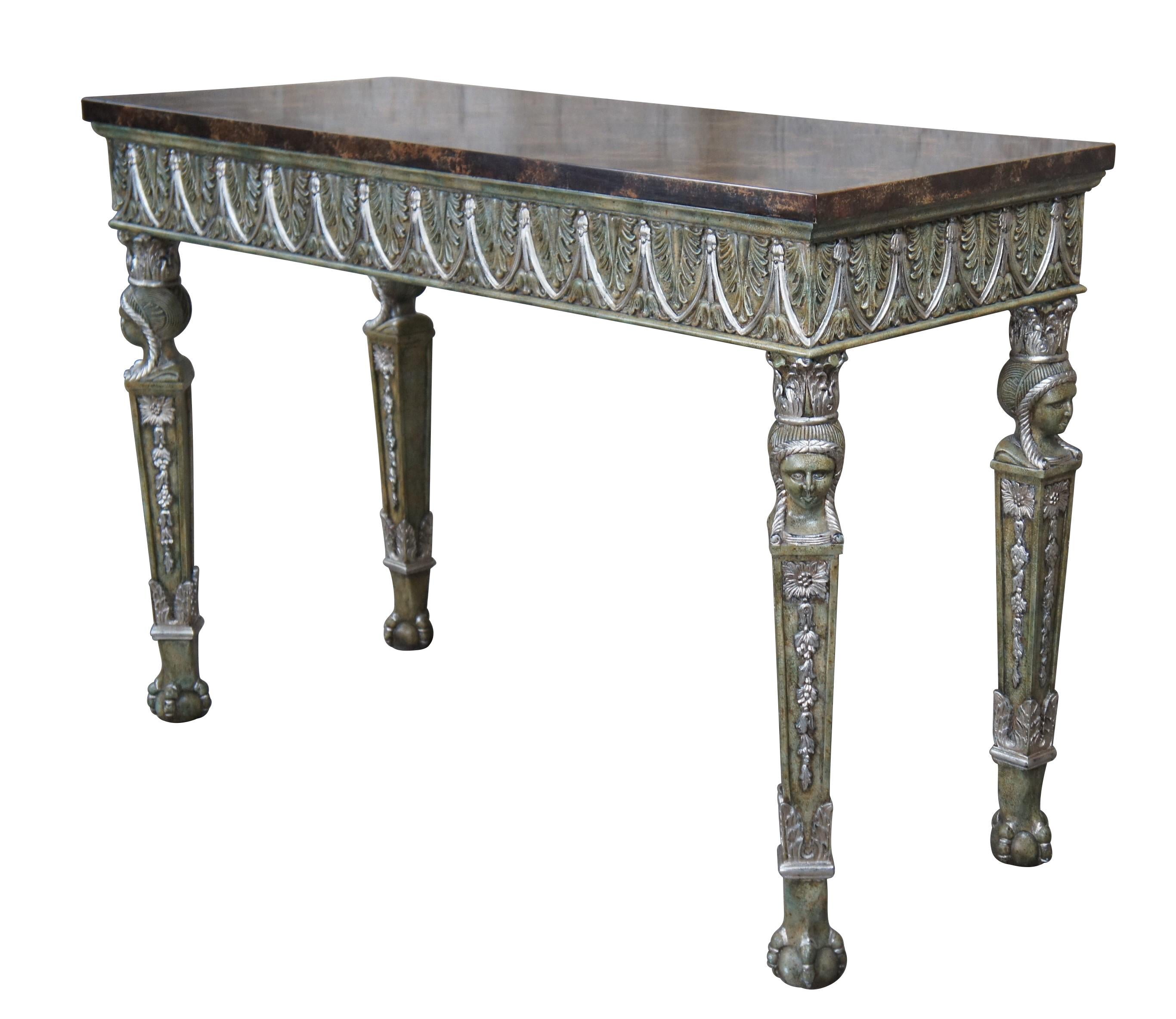 Vintage Maitland Smith console / entry sideboard table featuring French Empire & Egyptian revival styling with faux marble top over acanthus skirt supported by tapered column legs with caryatid (bust) of a female figure and ball and claw feet. Base