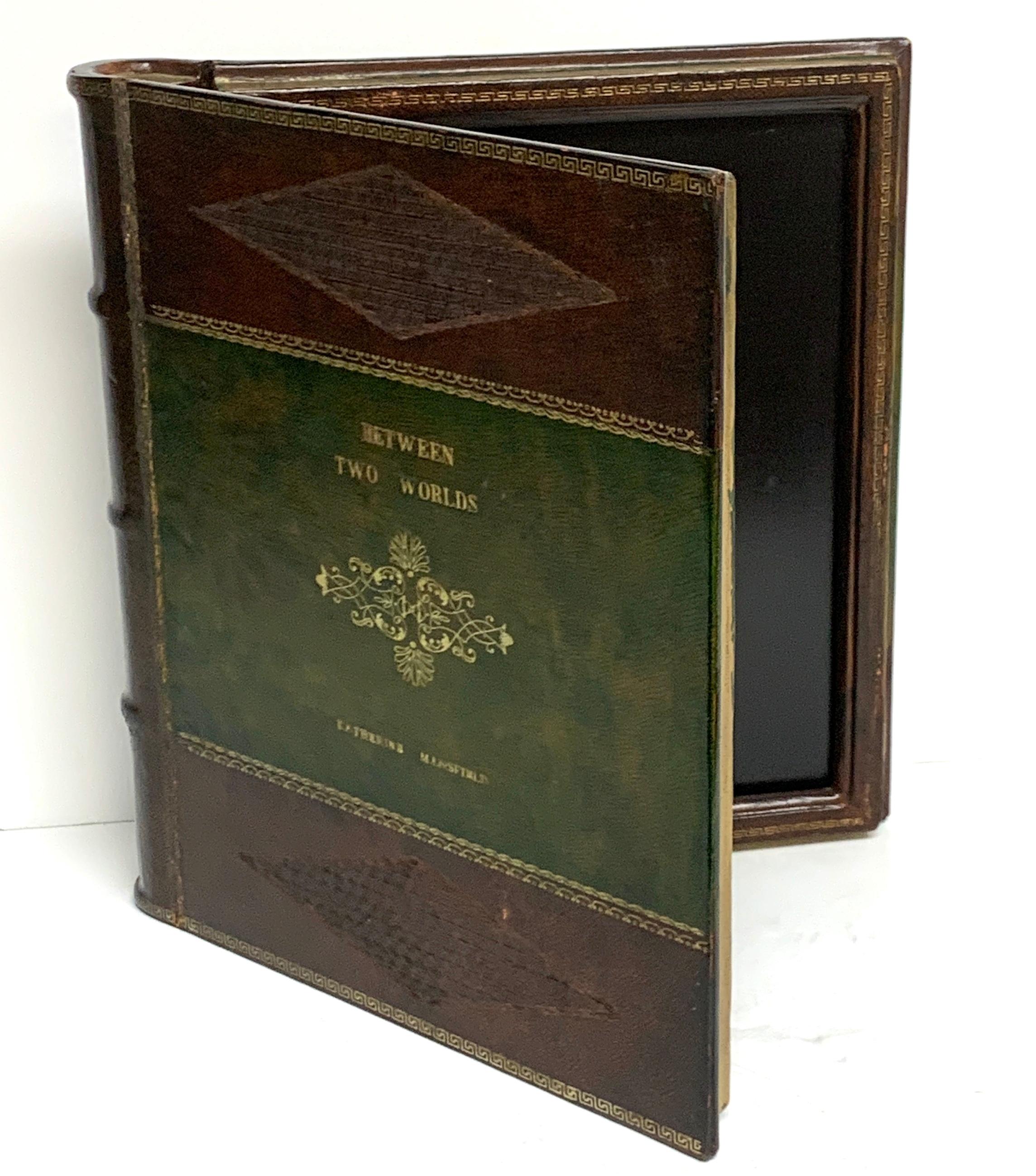 Maitland Smith embossed leather book motif double photograph frame, beautiful two color leather with gold tooling and lettering, titled 'Between Two Worlds' by Katherine Mansfield
The frame holds two photos 9.5