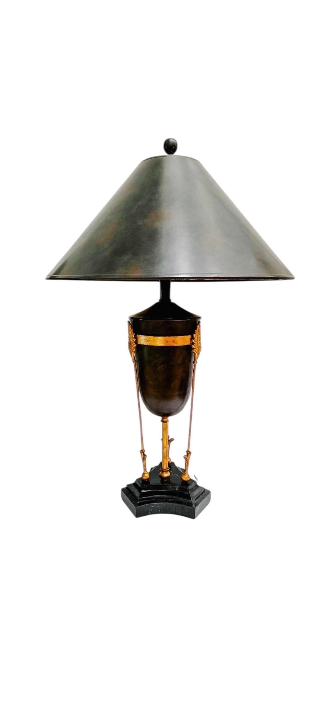 Dark toned tole urn silhouette, ornate gold bronzed arrow like supports. Classical Greek and Roman design inspired. Large hard matte black shade  with a soft taper. An iconic Maitland Smith masterpiece. Gorgeous lighting for entryway, office or
