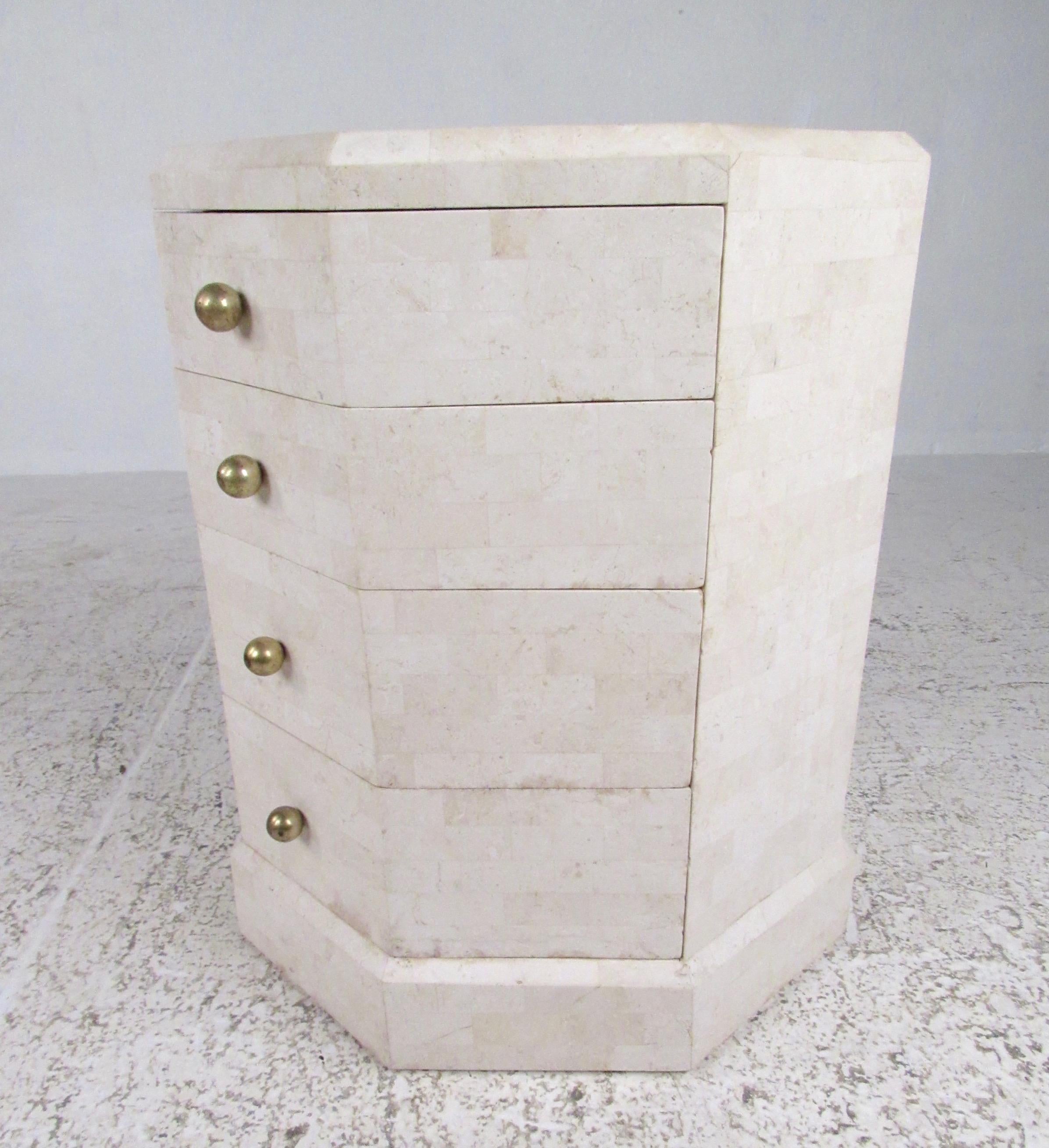 This vintage modern end table features Maitland-Smith tessellated stone finish, brass drawer pulls, and four spacious drawers for storage in any setting. Manufacturers 