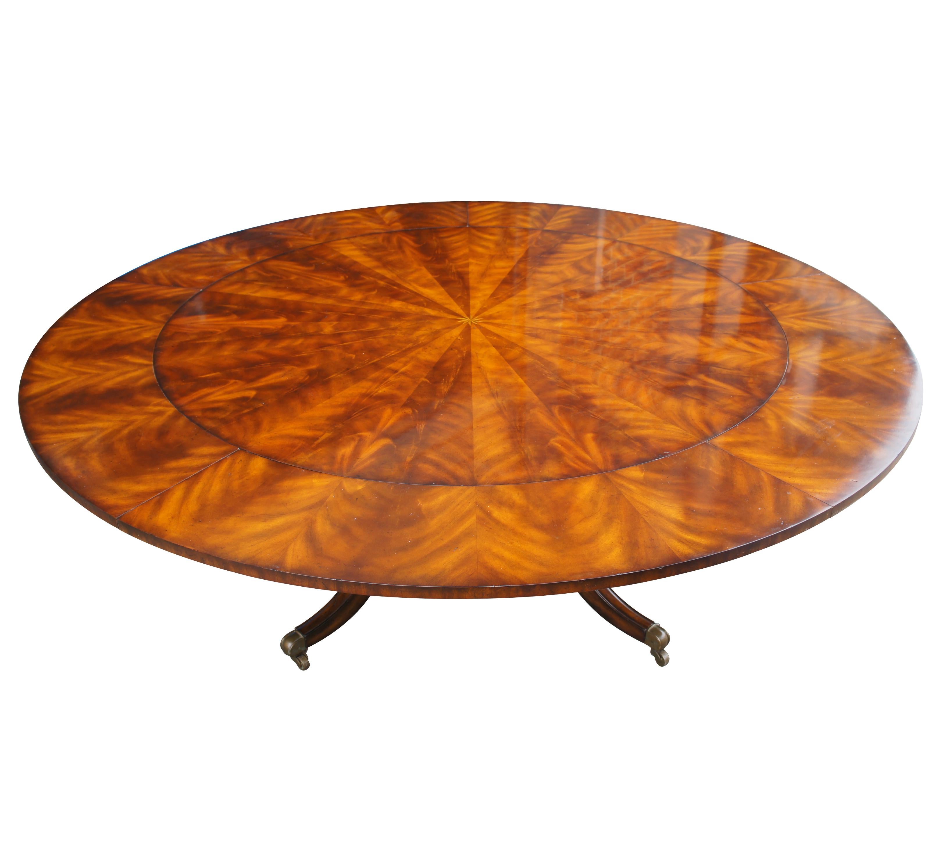 Maitland Smith Roundabout Dining Table.  Inspired by English Regency styling.  Features a two tone crotch mahogany extendable top with star inlay at the center over a birdcage base with turned baluster supports leading to downswept legs with brass