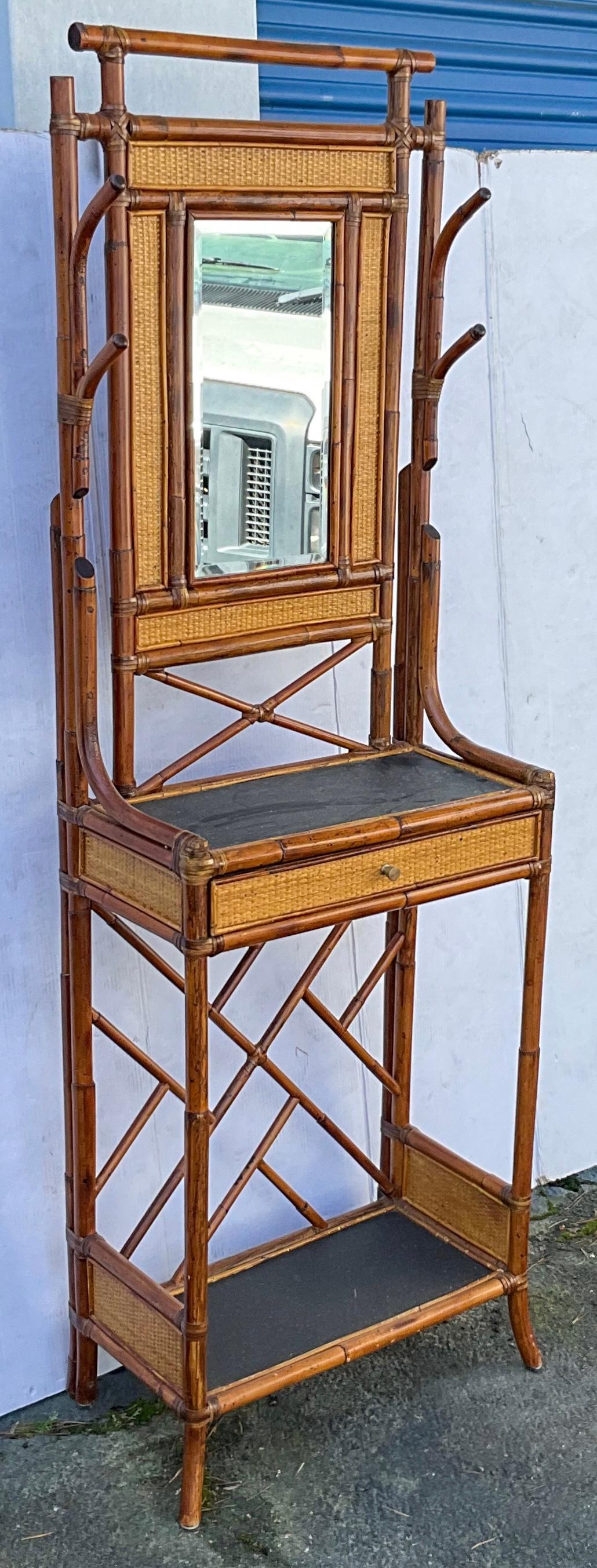 This is an English style burnt bamboo / faux tortoise hall tree by Maitland-Smith. It is marked and dates to the 1980s. It is a versatile size and even has a single drawer that is perfect for keys. It includes hooks for leashes and hats. 

My