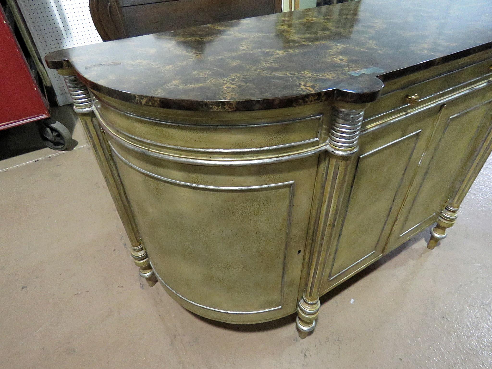 Maitland Smith faux marble-top distressed painted commode with 1-drawer over 4 doors containing 3 shelves.