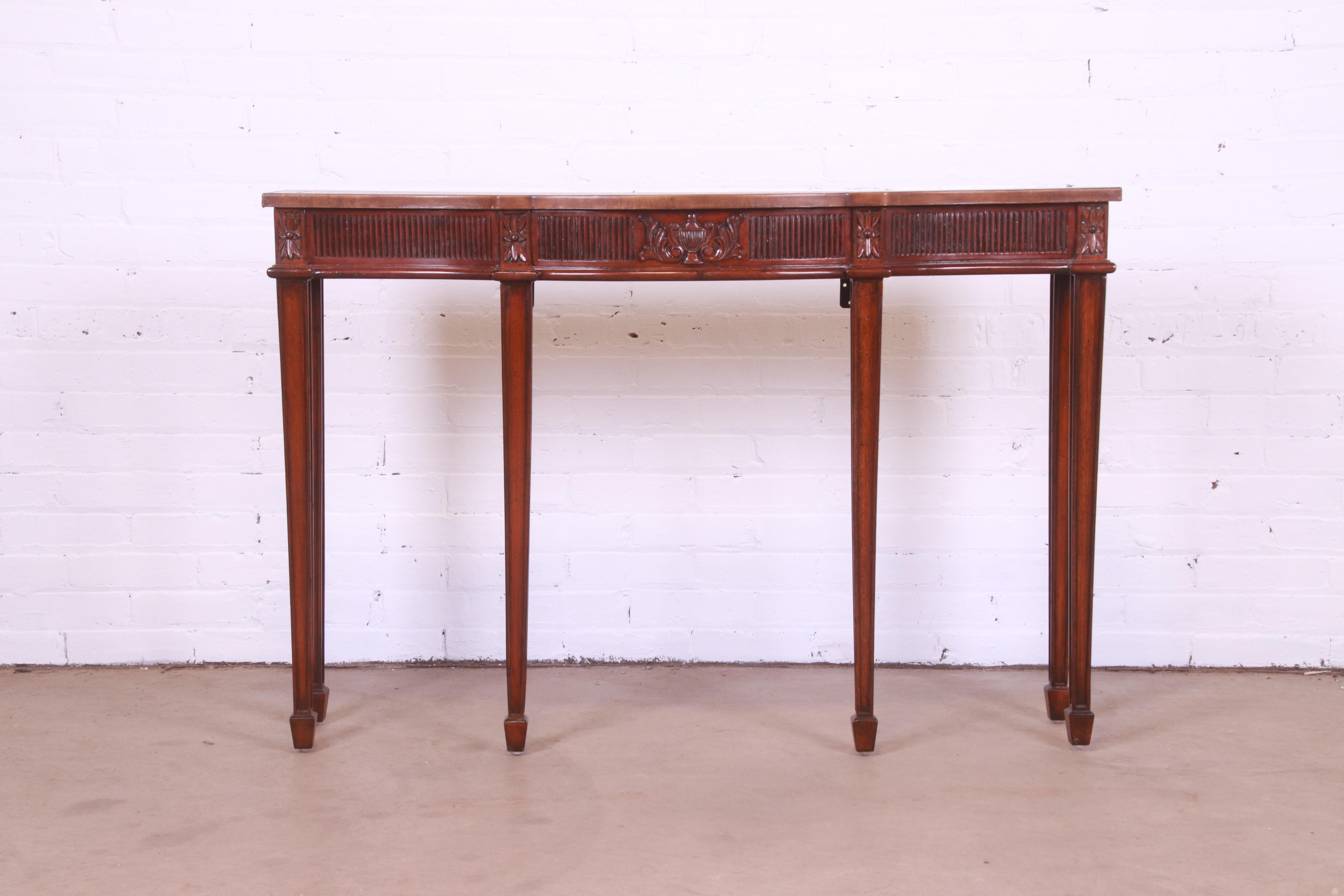 A gorgeous Federal style bow front console table or sofa table

By Maitland Smith

Late 20th Century

Carved mahogany, with embossed leather top.

Measures: 48
