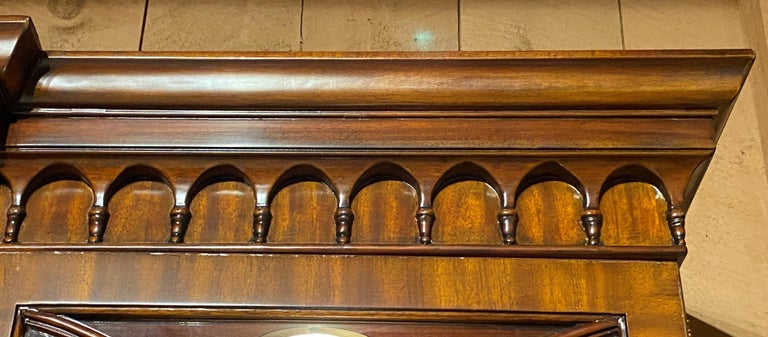 A spectacular Federal style carved two part mahogany breakfront bookcase, server, or china cabinet made by Maitland-Smith, with nicely carved cornice surmounting and upper case with three glazed glass doors, opening to a lighted interior with three