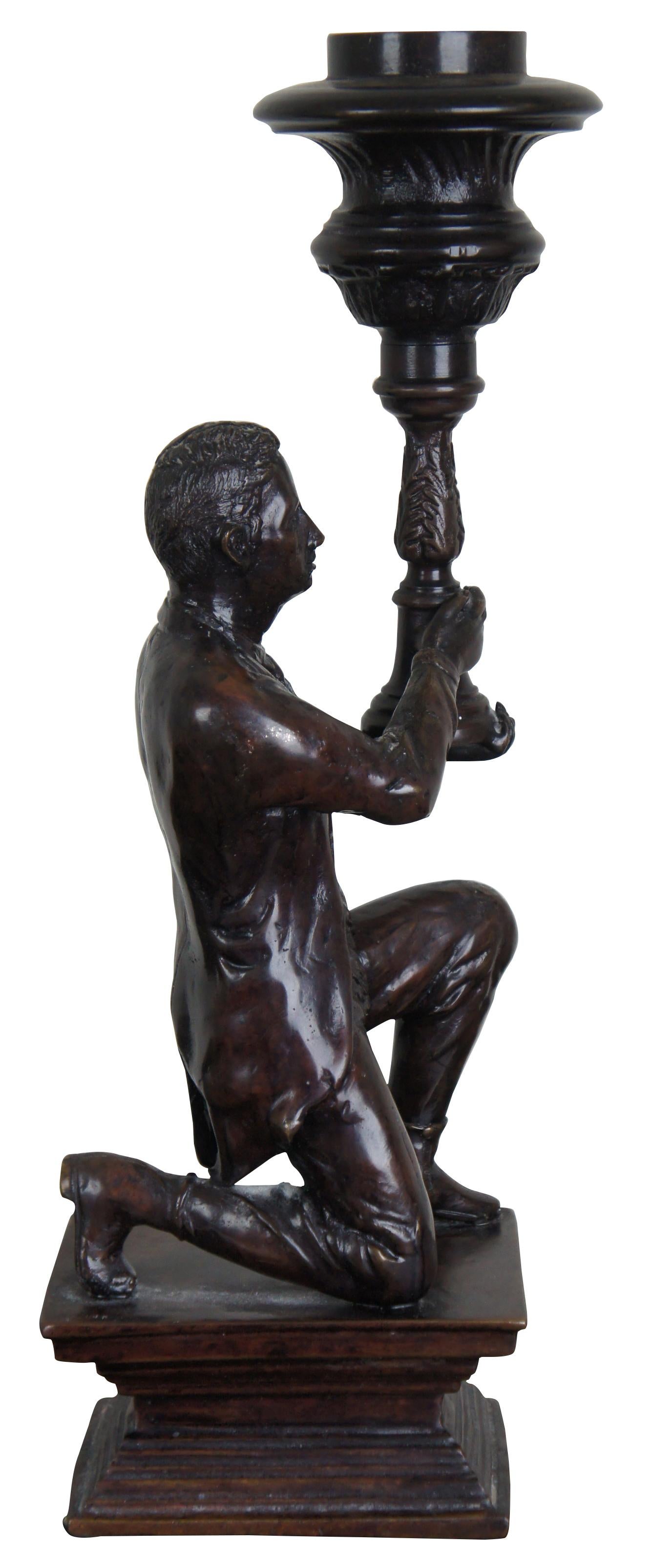 Maitland Smith sculptural bronze candlestick, late 20th century. Features a colonial man kneeling with torch, 18