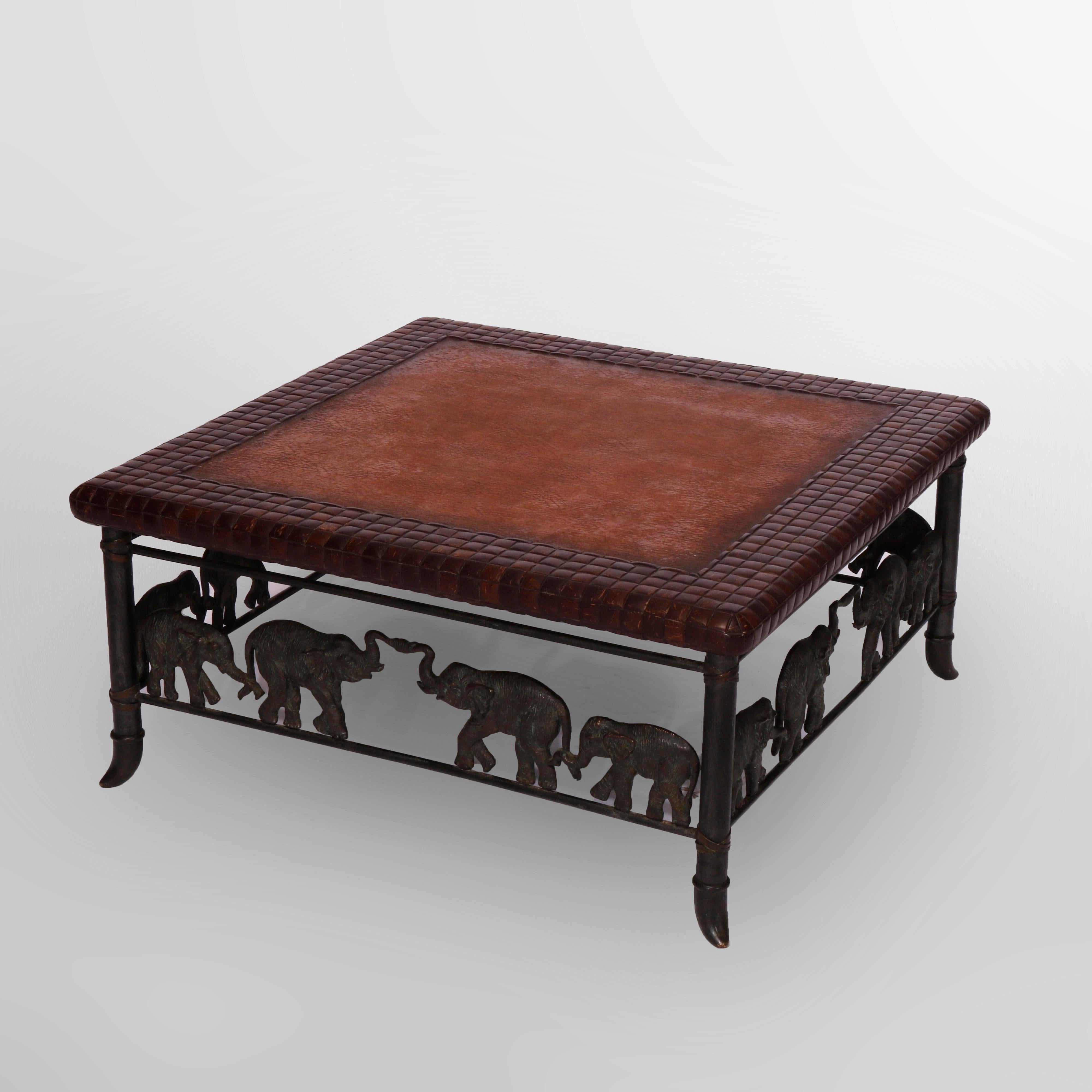 A figural low table by Maitland Smith offers leather top over cast bronze frame having stretchers with elephants, maker label as photographed, 20th century

Measures - 17.5'' H x 37.25'' W x 37.25'' D.

Catalogue Note: Ask about DISCOUNTED DELIVERY