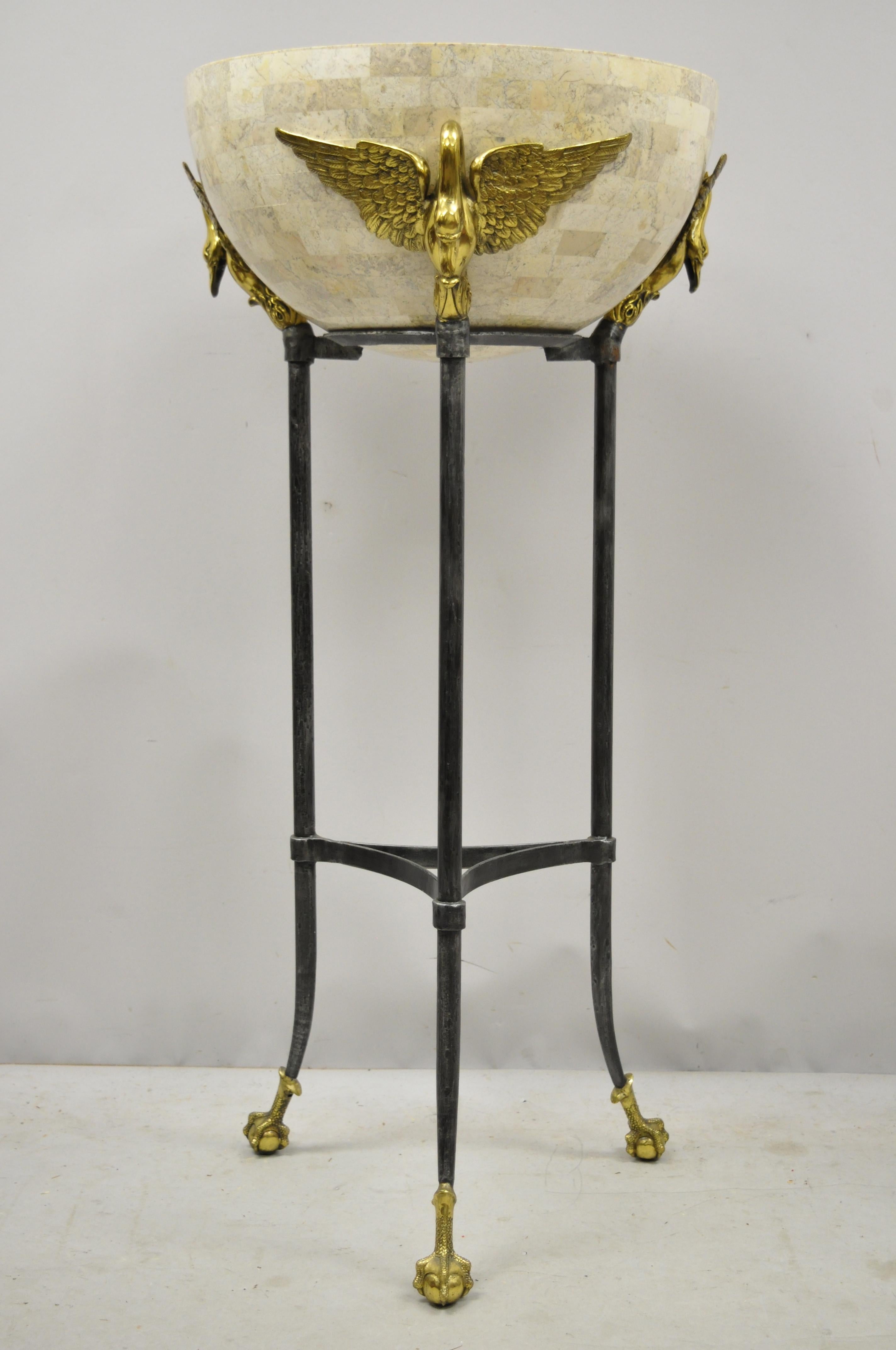 Maitland Smith French empire brass swan tessellated marble planter jardinière. Item features fiberglass jardinière with tessellated marble exterior, solid brass winged swans, iron frame, brass ball and claw feet, original label, quality