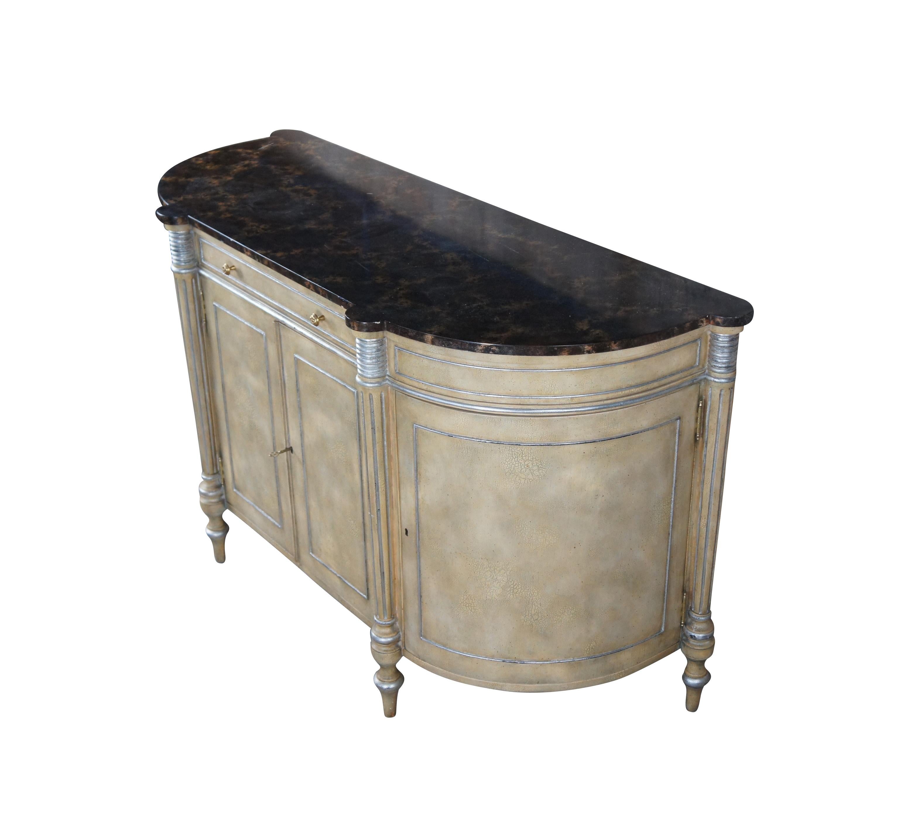 Maitland Smith French Louis XVI inspired sideboard, circa last quarter 20th century.  Made from hardwood with a painted finish. Includes a faux marble top and silver leaf accents.  Features a demilune or bowfront shape with a central drawer over