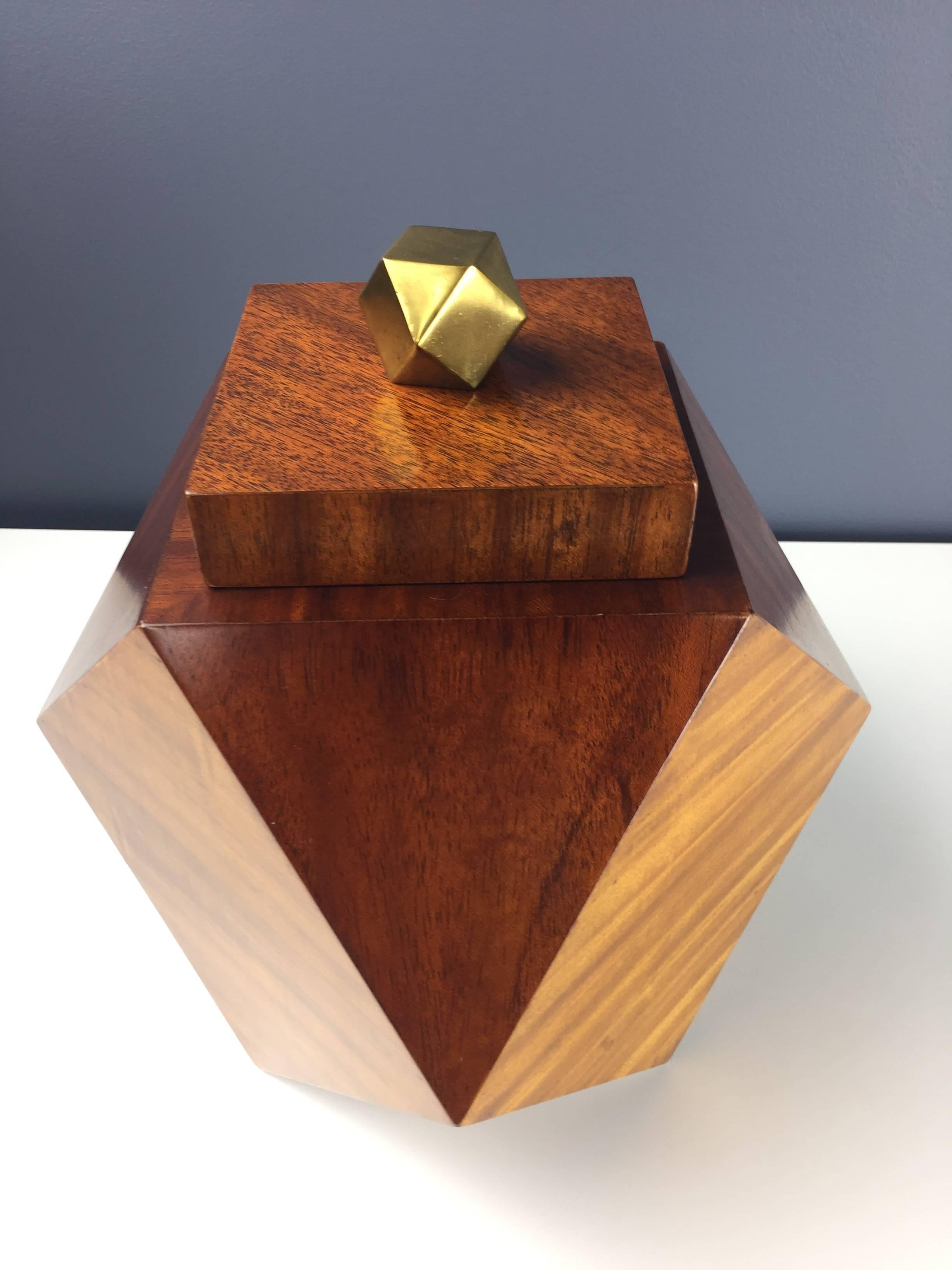 Beautiful octagonal mahogany lidded box with a handsome brass knob mirroring the box shape. This box is meticulously made with contrasting panels of mahogany.