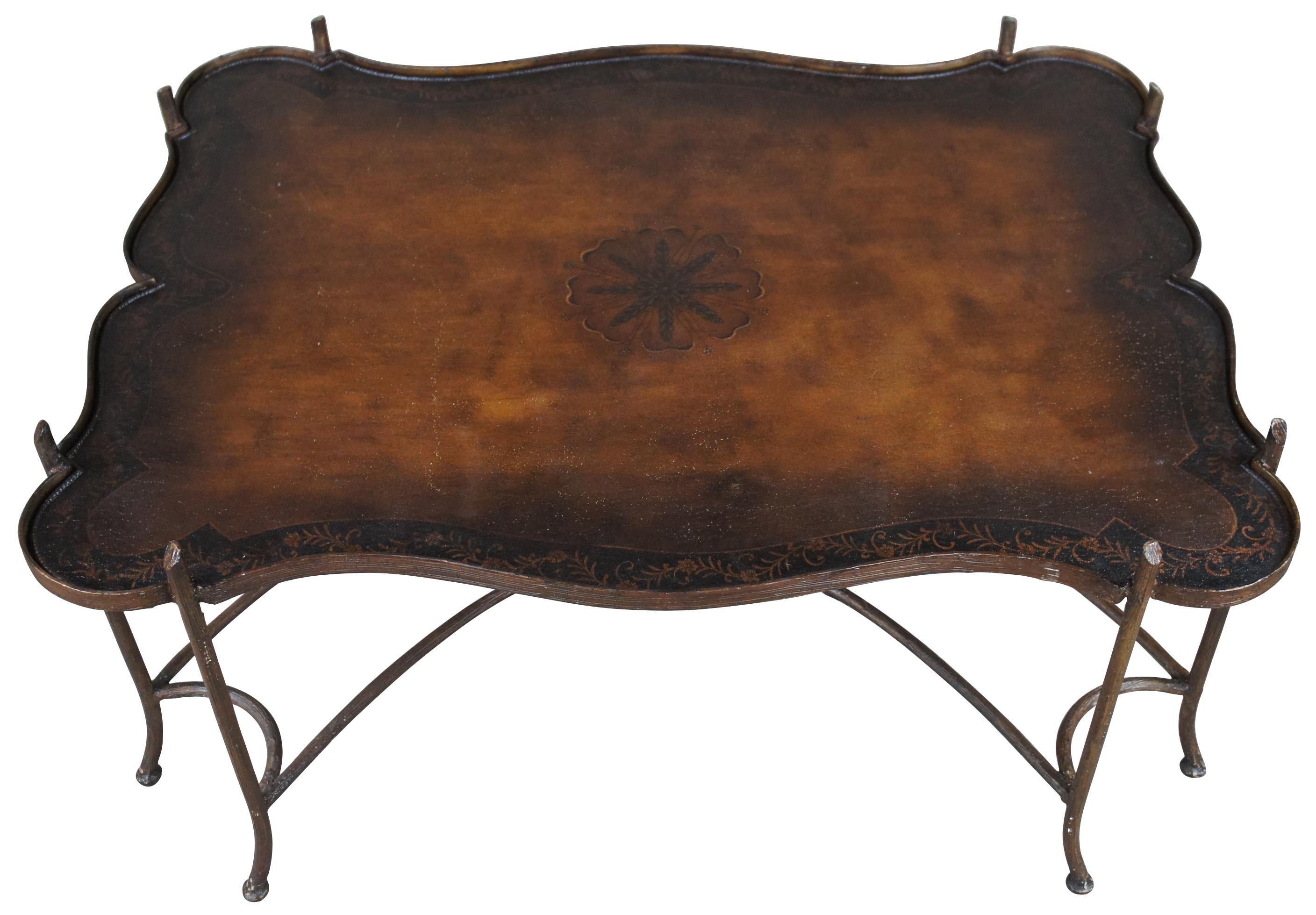 Gorgeous Maitland-Smith gilded faux bois iron coffee table in chinoiserie or Hollywood Regency style with tole painted metal tray style top, circa 1990.

This stunning gilt iron faux bois coffee table features a double curved x-base, double corner