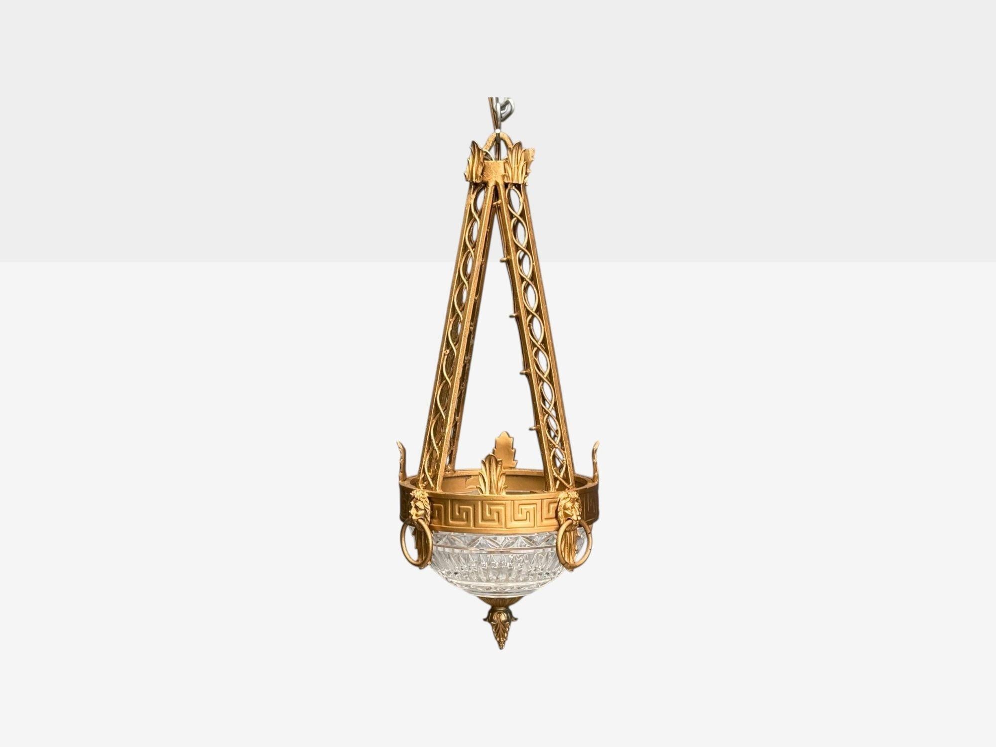 Maitland Smith, Neoclassical, Gilt Metal, Glass, Greek Key Motif, Pendant Light, 21st C.

Neoclassical style pendant light or chandelier having a painted metal frame, glass shade, and lion head rising mounts, designed and produced by Maitland Smith