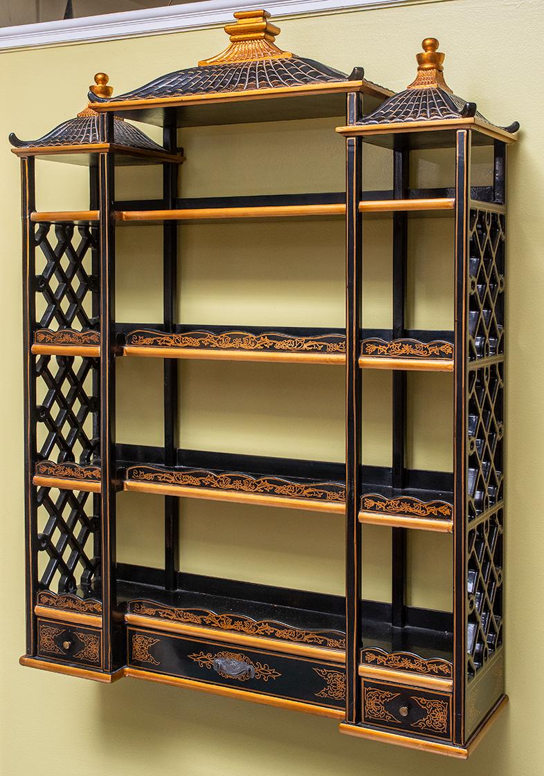 Maitland Smith hand painted black with gold highlights Chinese chinoiserie hanging wall shelf. Pagoda style top with three (3) drawers below.