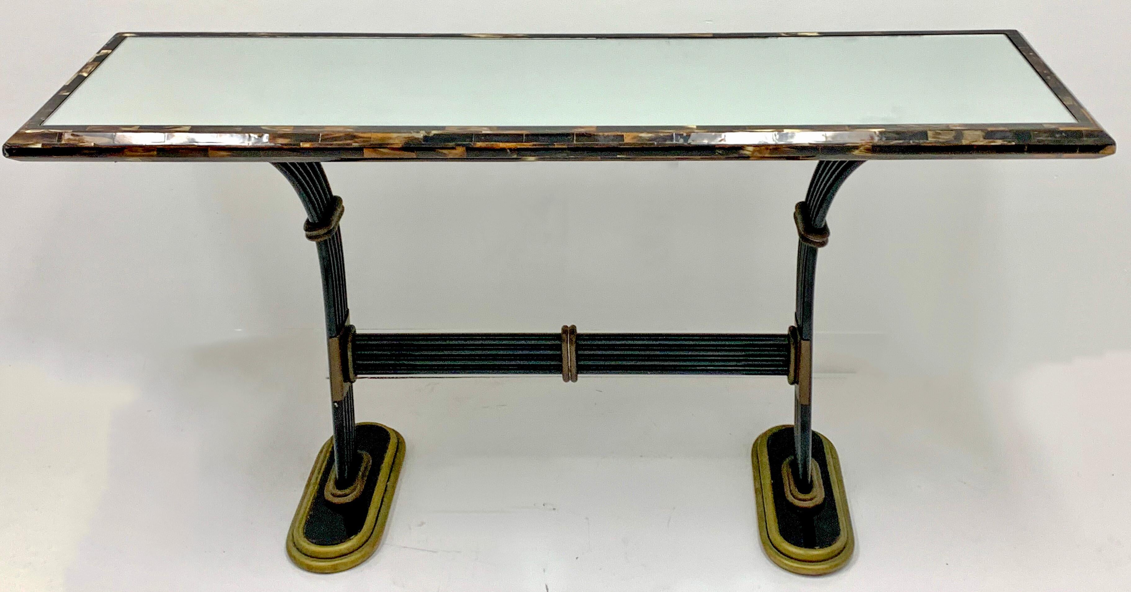 This is a 20th century Maitland-Smith mirrored console table with tessellated horn frame and cast bronze accents. It is marked and in very good condition.