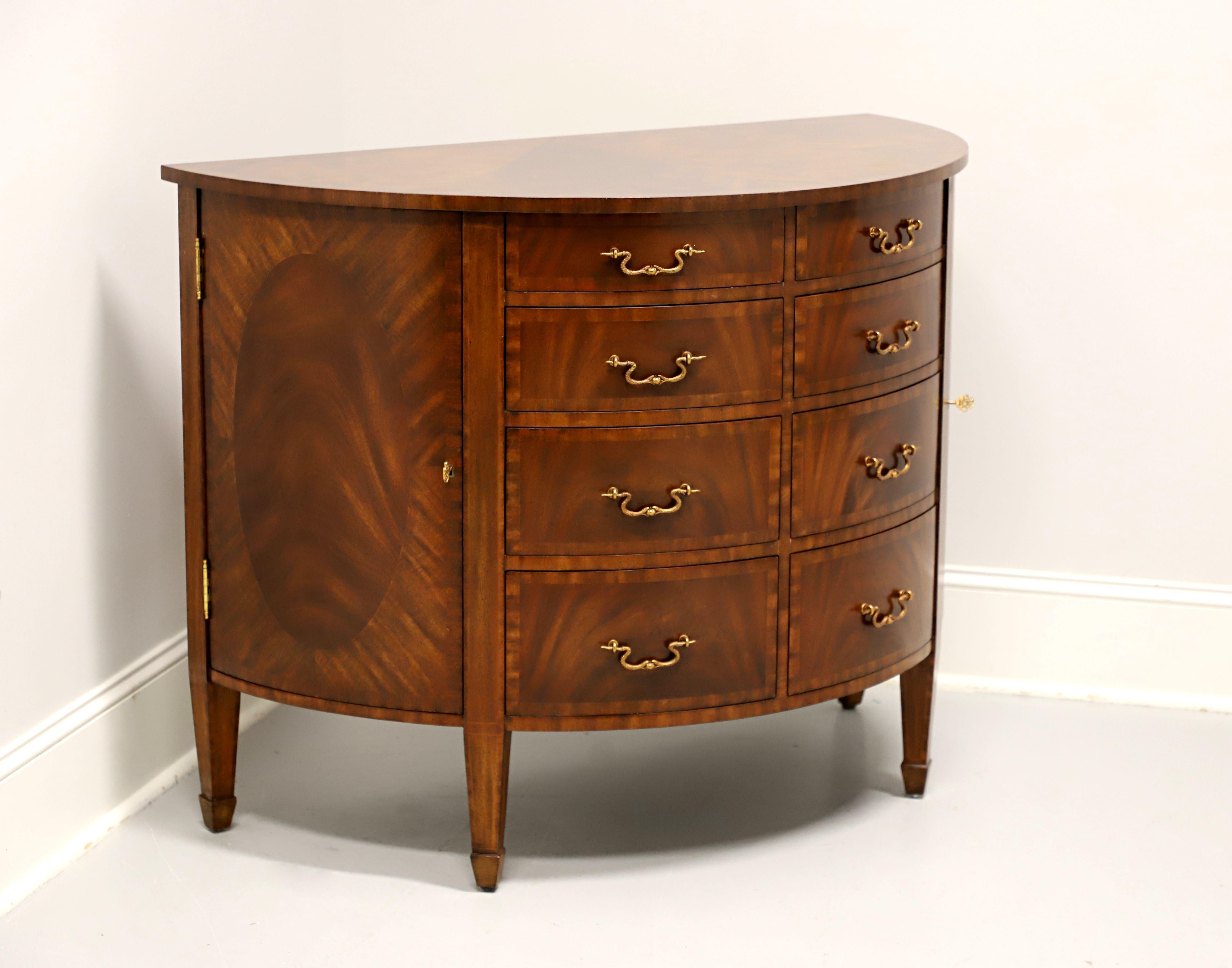 A Regency style demilune commode chest by Maitland Smith. Mahogany with distinctive brass hardware, banded inlaid flame mahogany top, banded drawer fronts, inlaid door panels, tapered straight legs, and spade feet. Features eight various size
