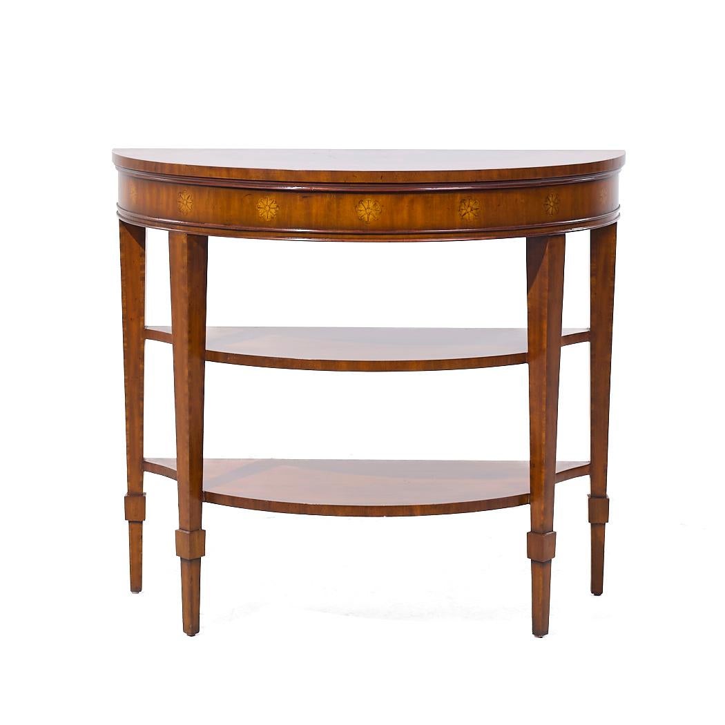 Maitland Smith Inlaid Mahogany Hepplewhite Demilune Console Table

This console table measures: 36 wide x 18 deep x 31.75 inches high

We take our photos in a controlled lighting studio to show as much detail as possible. We do not Photoshop out